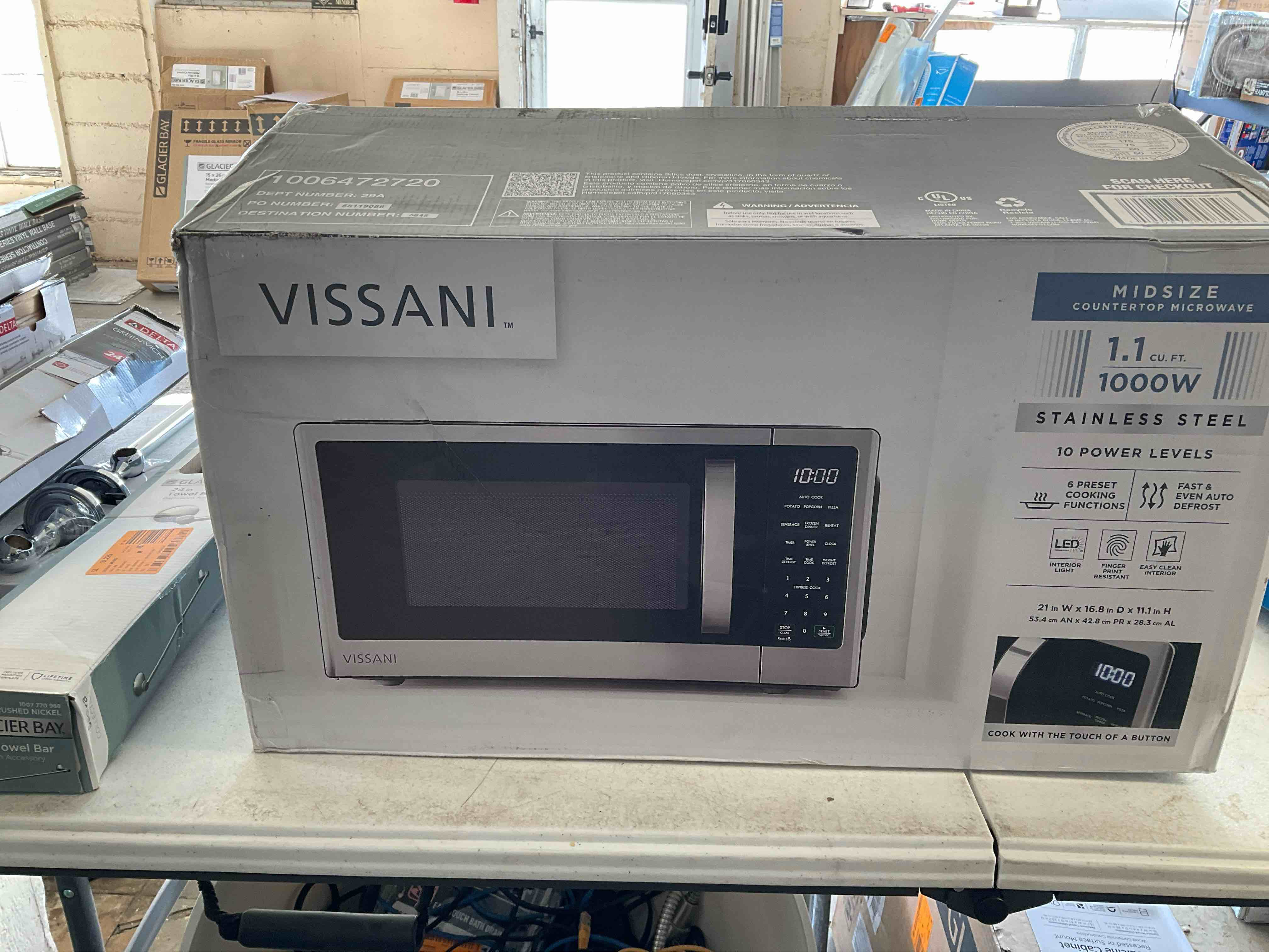 1.1 cu. ft. Countertop Microwave in Fingerprint Resistant Stainless Steel ** box is damaged but item is not effected ***