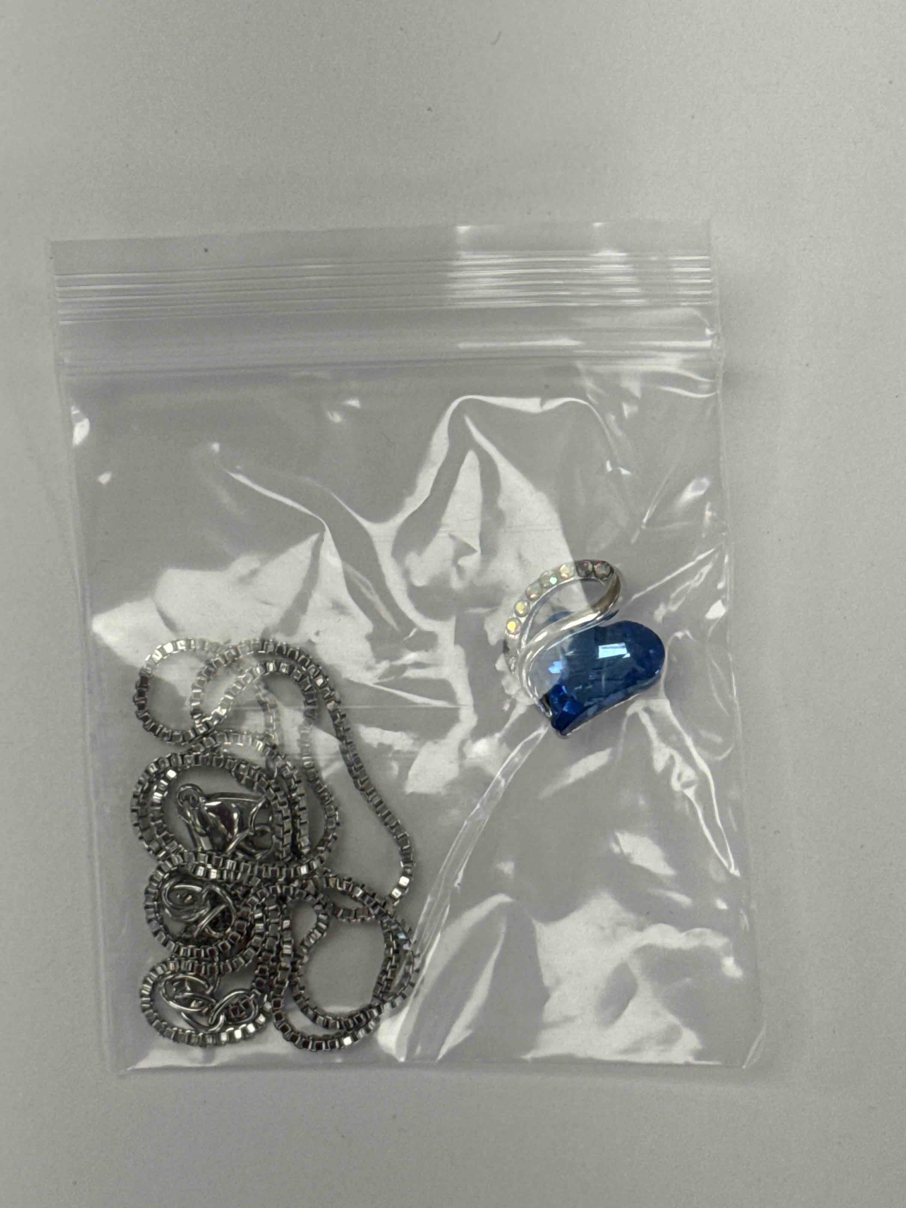 https://s3.amazonaws.com/lotting-images-prod/necklacedblue_1776781821421.jpeg