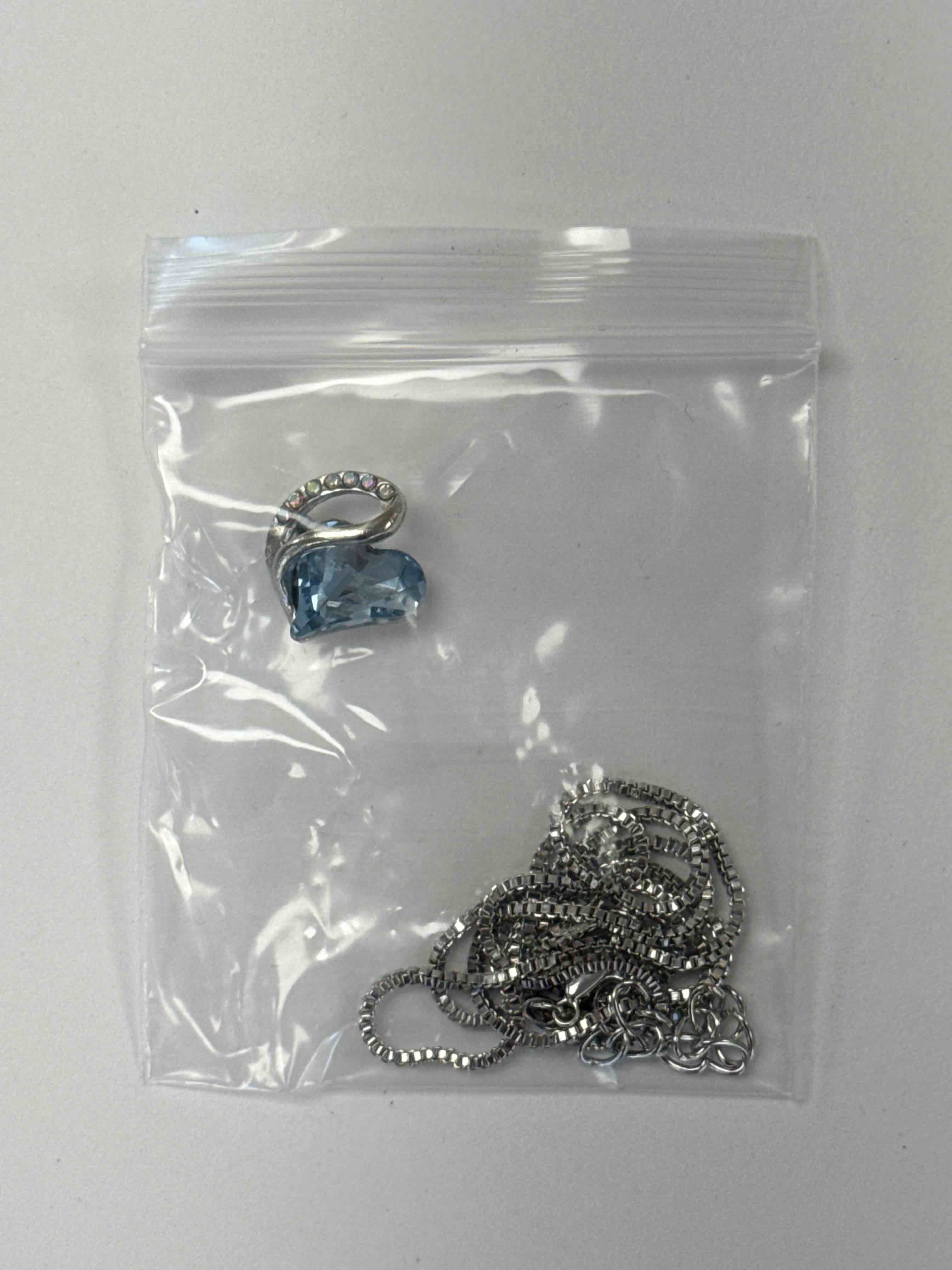 Condition photo showing New/Like New for elegant heart pendant necklace with sparkling crystals and silver chain