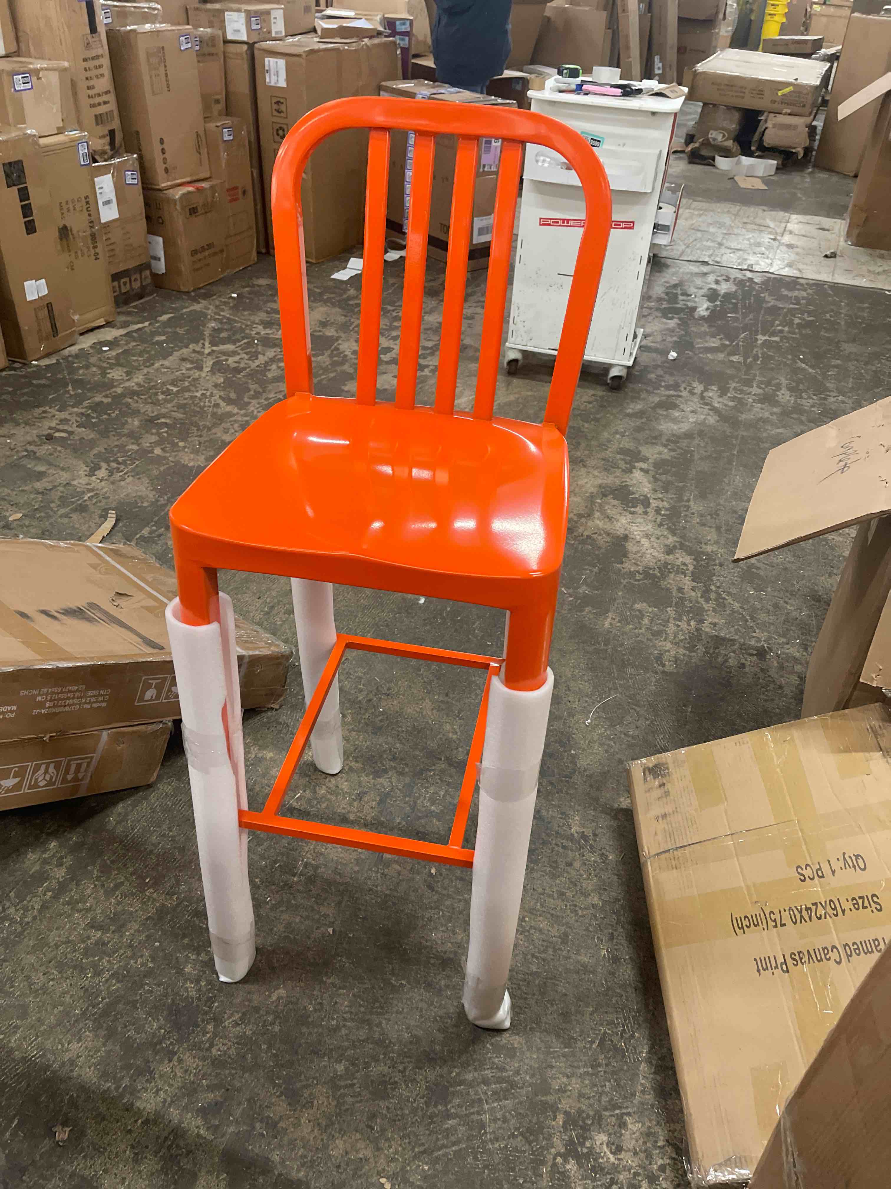 Condition photo showing New/Like New for 24.5 in. orange metal bar stool