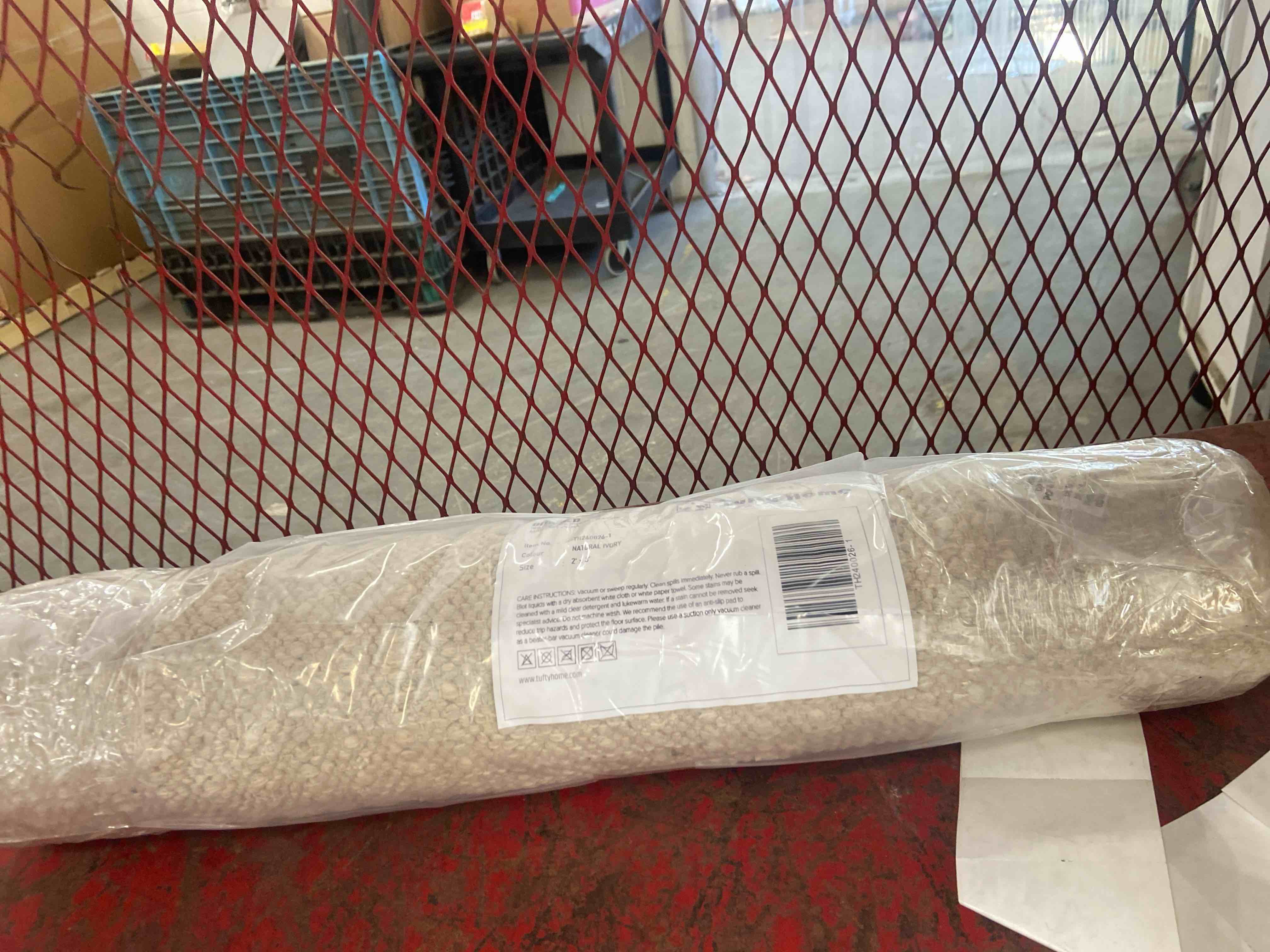 Condition photo showing New/Like New for braided tan indoor/outdoor rug