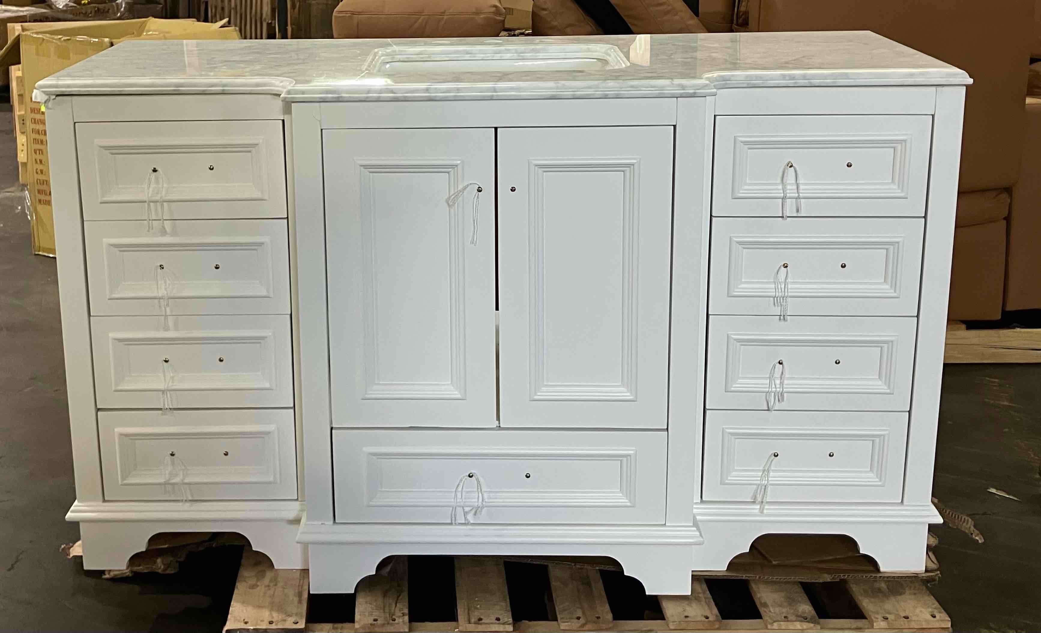 Condition photo showing As Is for kitchenbathcollection nantucket 60" single bathroom vanity with carrara marble top - (as is because of some damage to the rear right side of vanity, and cracks/chips to the marble countertop, pictured. also the middle bottom drawer track will need repaired)