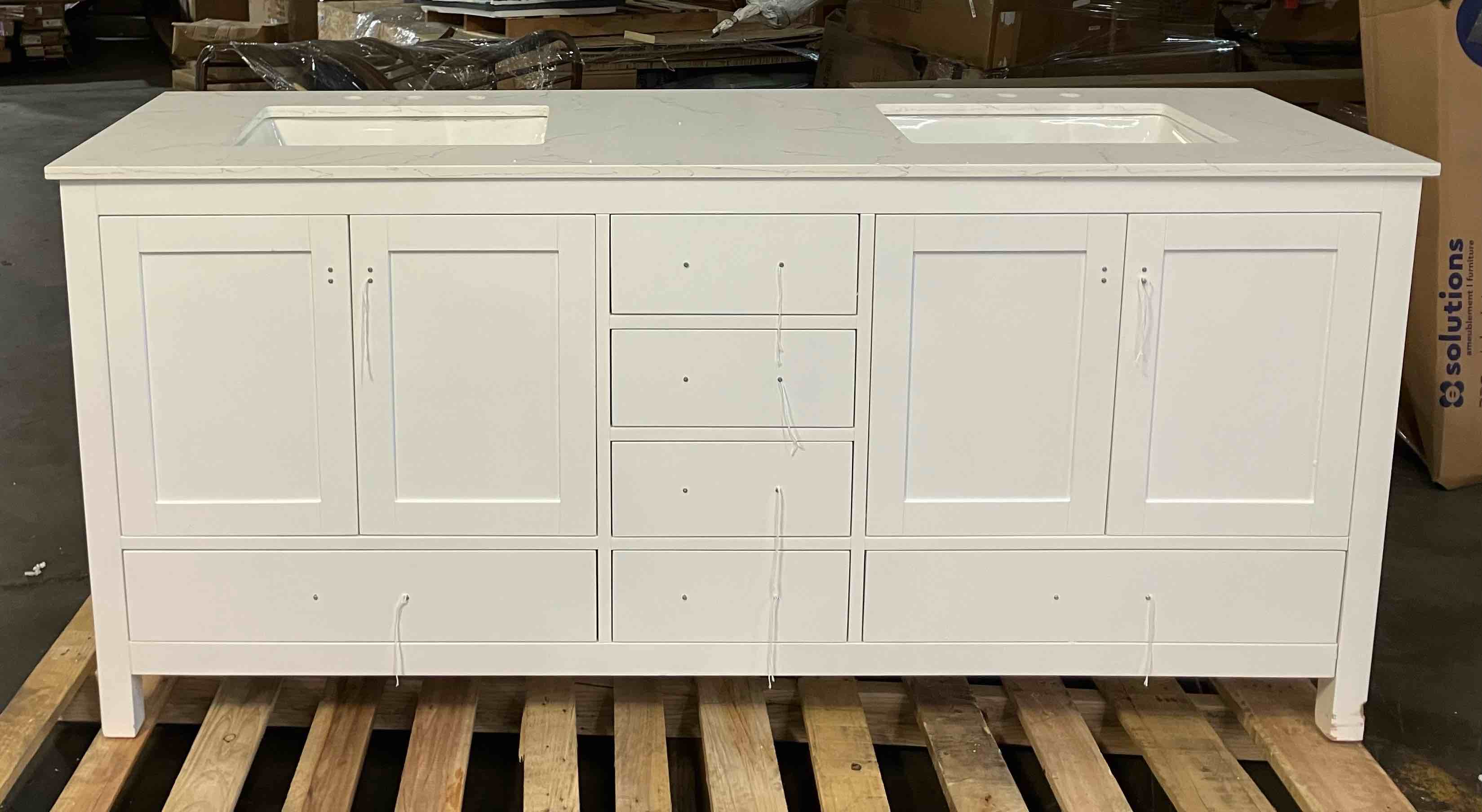 Condition photo showing Good Condition for aberdeen 72 in. double sink white bath vanity with white carrara quartz top (assembled) - (good condition because of minor damage to the front right leg of vanity, pictured, a small chip in the other front leg. item is also missing some of its foot levelers)