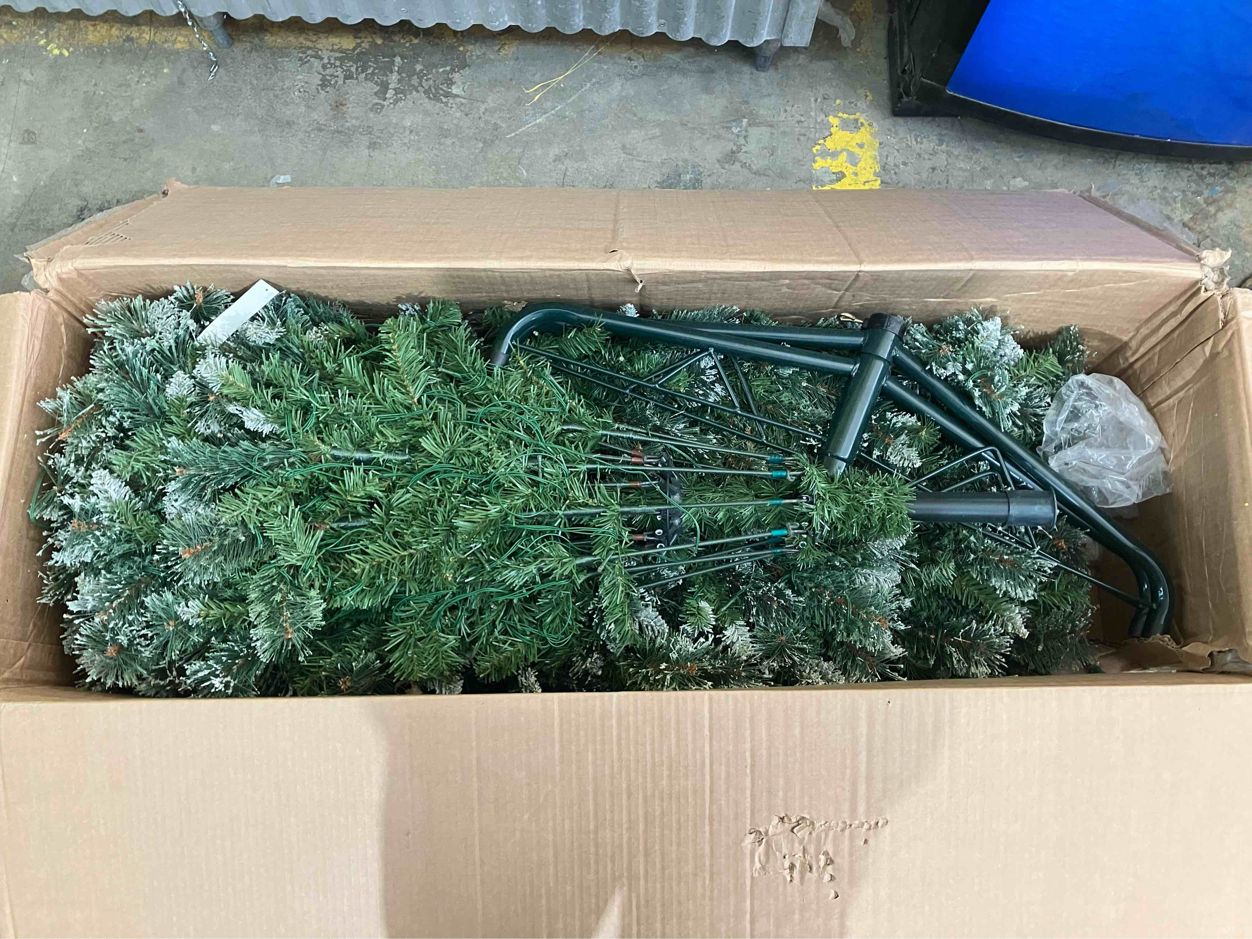 Condition photo showing As Is for Nearly Natural 10ft. Wisconsin Slim Snow Tip Pine Artificial Christmas Tree with 1050 Clear LED Lights - (As is because lights may not work/may need maintenance, and there is some damage to the plastic section connectors, pictured)