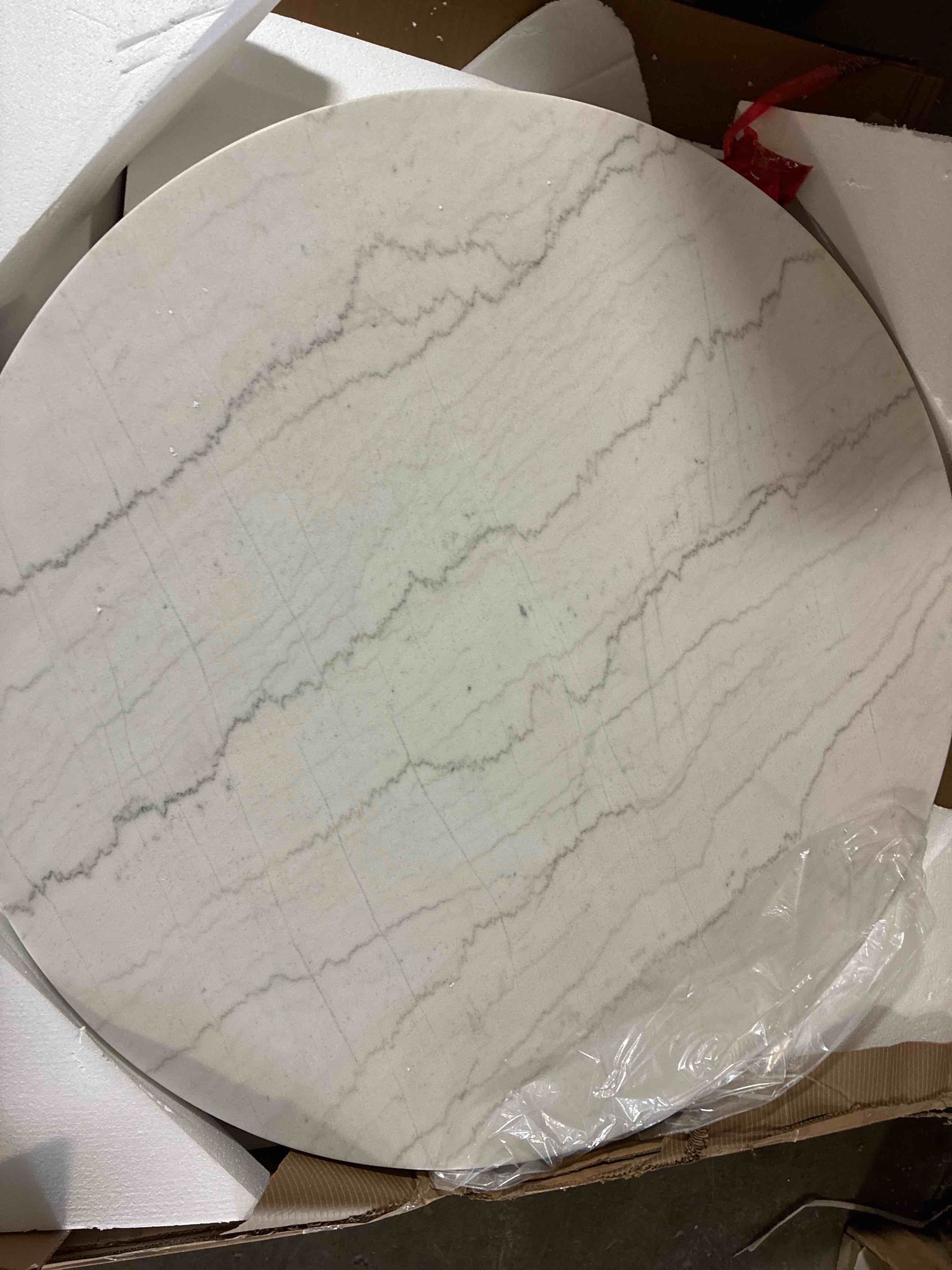 Condition photo showing New/Like New for Xena White Solid Marble 52" Round Dining Table with 5 Piece Black Timber Wood Legs, Small .5” chip on edge, otherwise brand new. 30'' H X 52'' W X 52'' D
