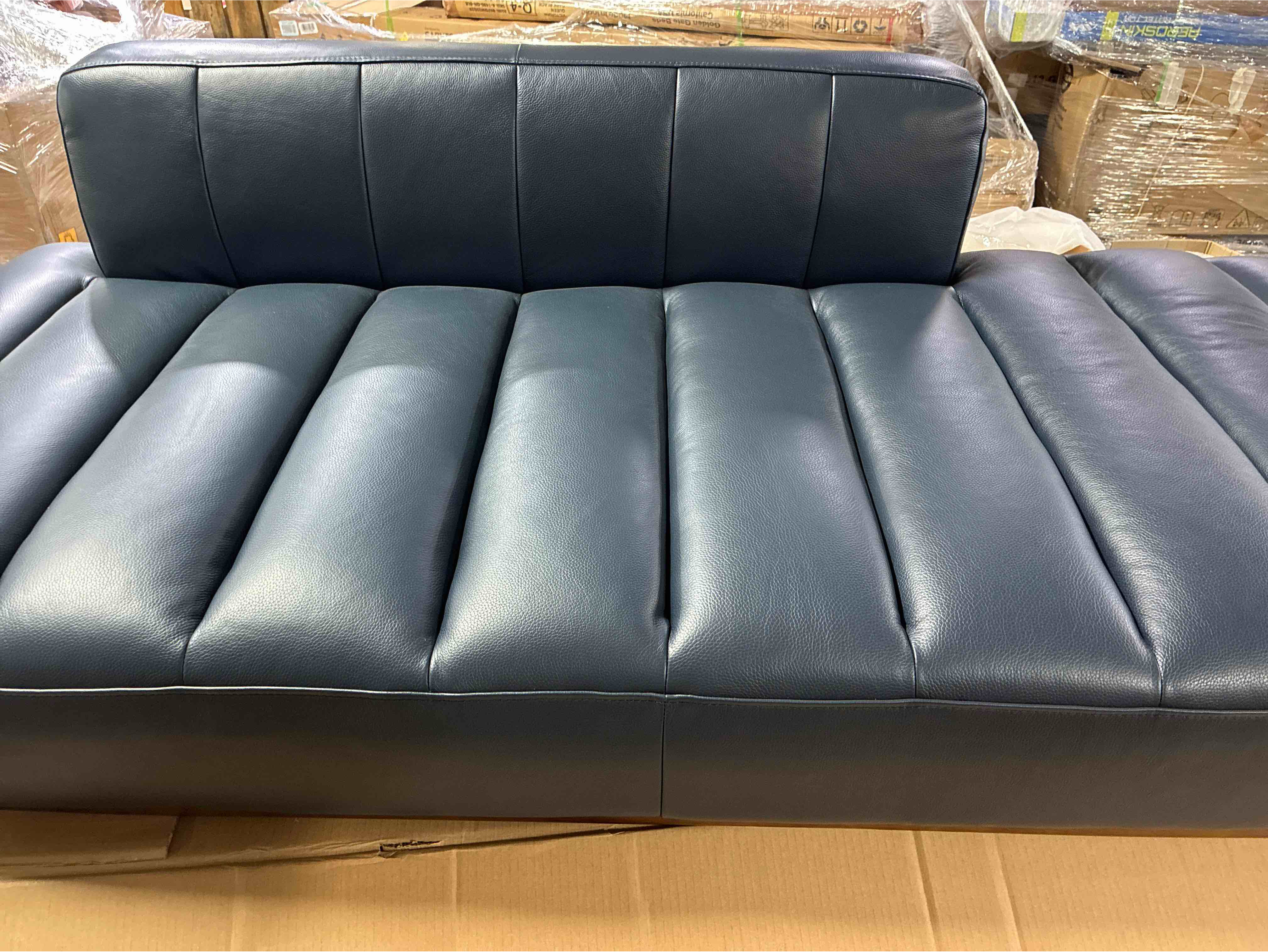 Condition photo showing New/Like New for Novi Genuine Leather Navy Blue Upholstered Line Tufted Daybed with Hazelnut Ash Wood Trim. 25.98'' H X 35.04'' W X 77.17'' L
