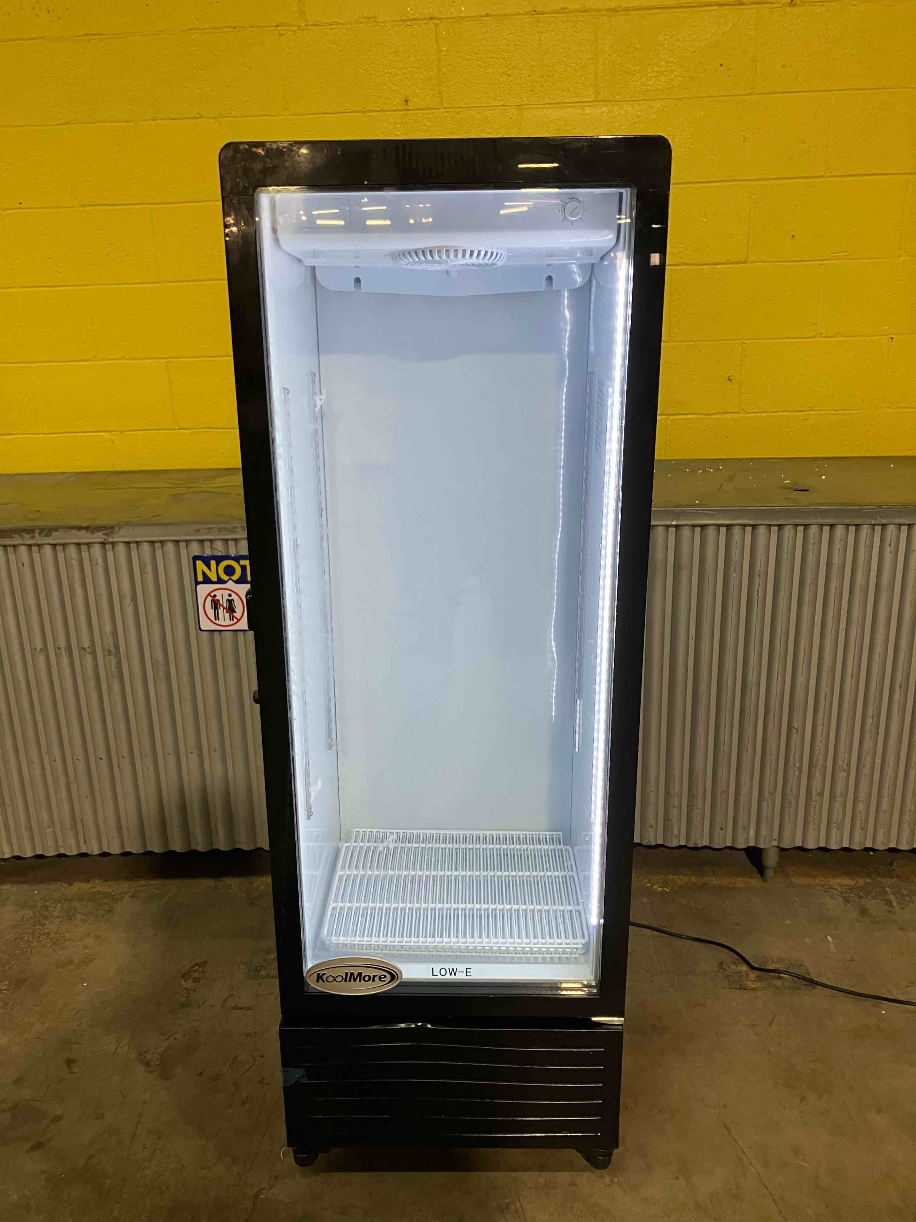 Condition photo showing Good Condition for KOOLMORE 21”x 59.5” One Glass Door Commercial Display Merchandiser Refrigerator Cooler in Black, ETL Listed, 8 cu. ft. (KM-MDR-1GD-8C) - (Good condition because fridge has a bent bottom plate, a bent rear grate, dents and dings, and does not come with keys for the lock. Function is perfect, cosmetic damage only)