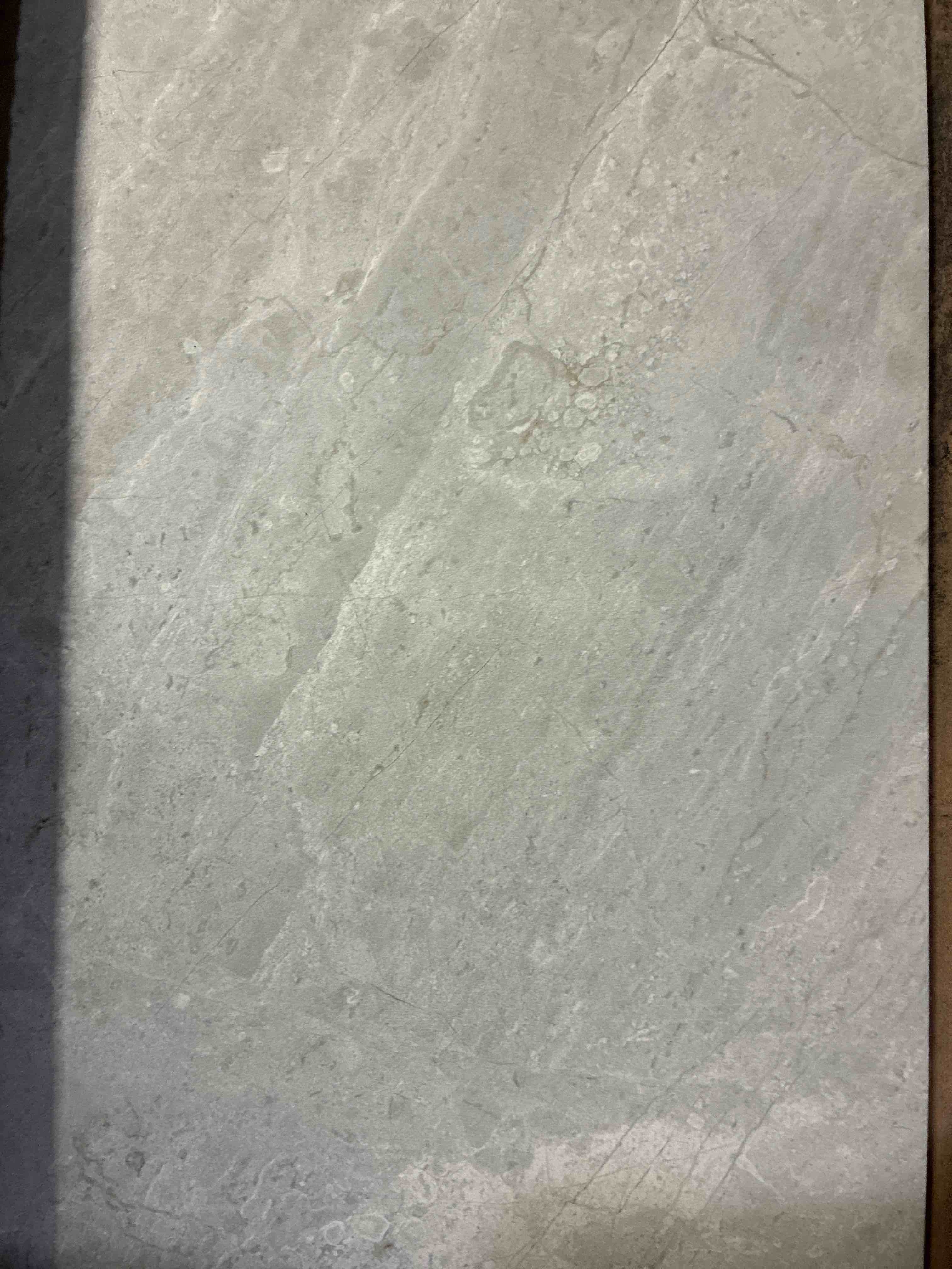 Condition photo showing New/Like New for bakersfield pumice 12x24 grey marble porcelain tile with white veining. 96 sq/ft total