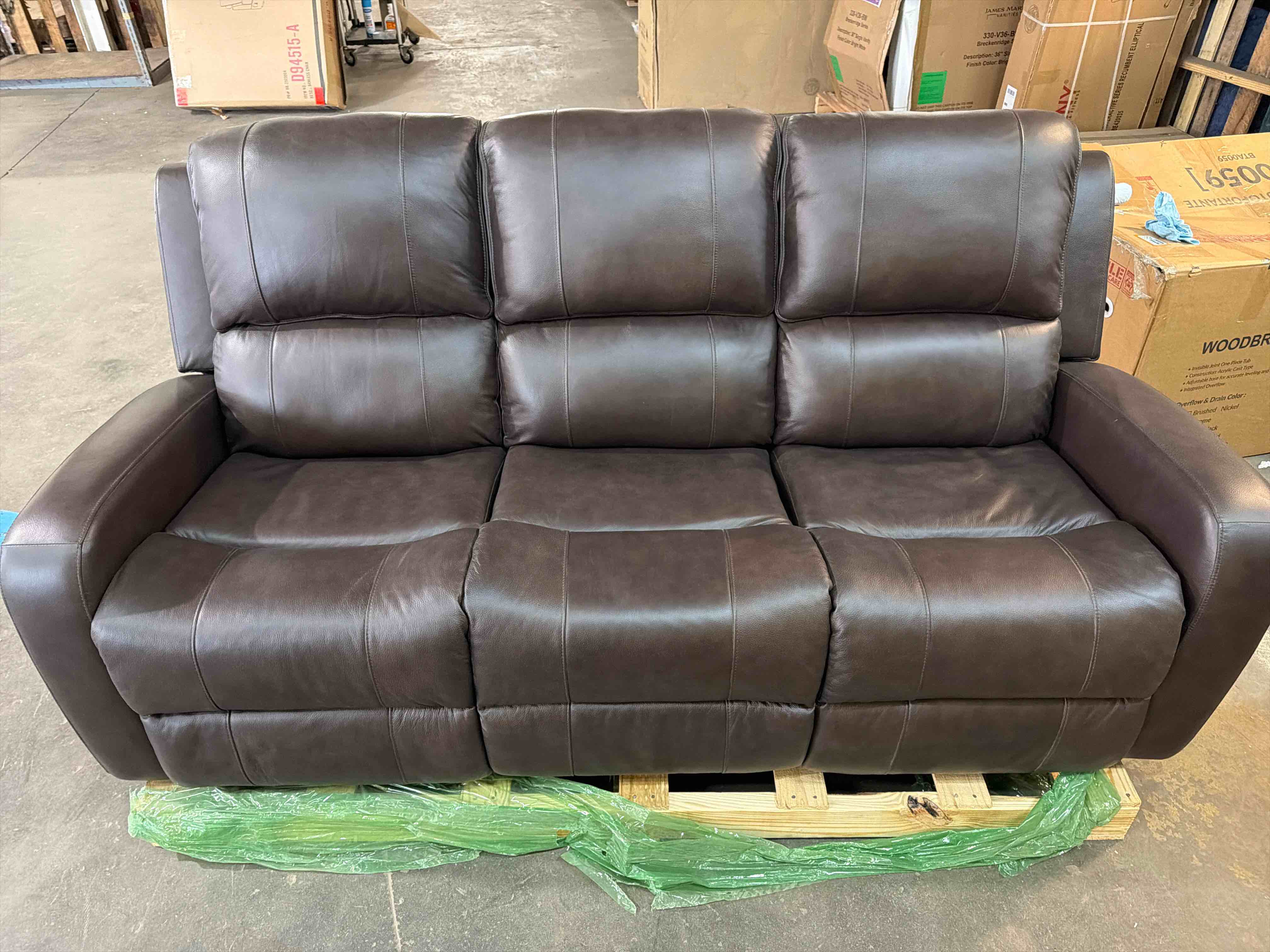 Condition photo showing New/Like New for austin brown genuine leather double reclining sofa, 78 x 37.5 x 39h - (item is new/like new, but does have hairline scratches on left cushions)