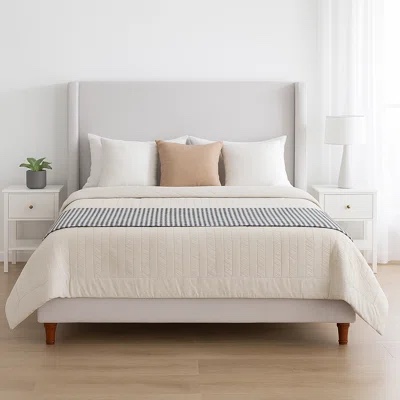 White Boucle Full Size Wingback Bedframe with Light Wooden Legs. One leg needs replaced can be purchased through Amazon, needs some deep cleaning along corners