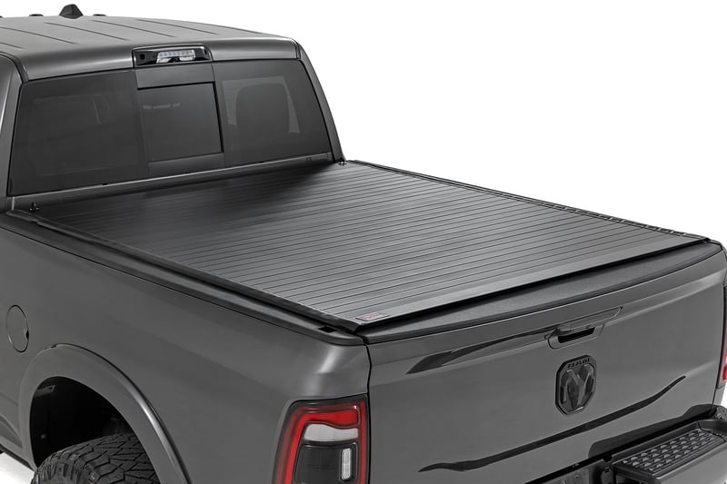 matte black hard roll up cover with durable aluminum slats, for ram 1500(09-18)/2500(10-26), supports up to 600lbs of weight, slide lock latching mechanism, nylon safety straps with quick release clips