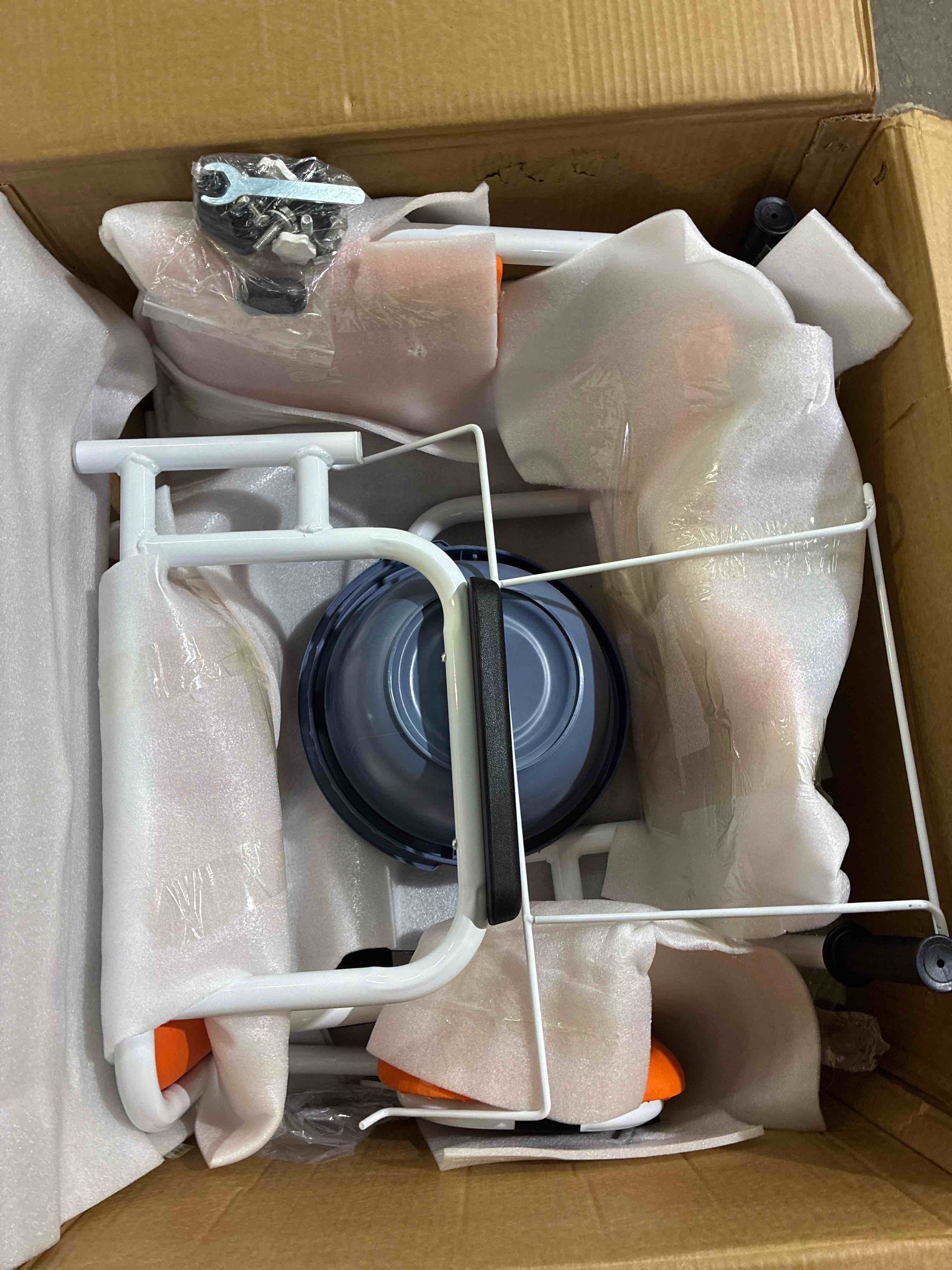 Condition photo showing New/Like New for orange and white patient lift transfer chair for home, 440lbs capacity,equipped with a hydraulic lift bar, commode, and dining table. 180° split seat. wheels show sign of usage, everything else brand new. 