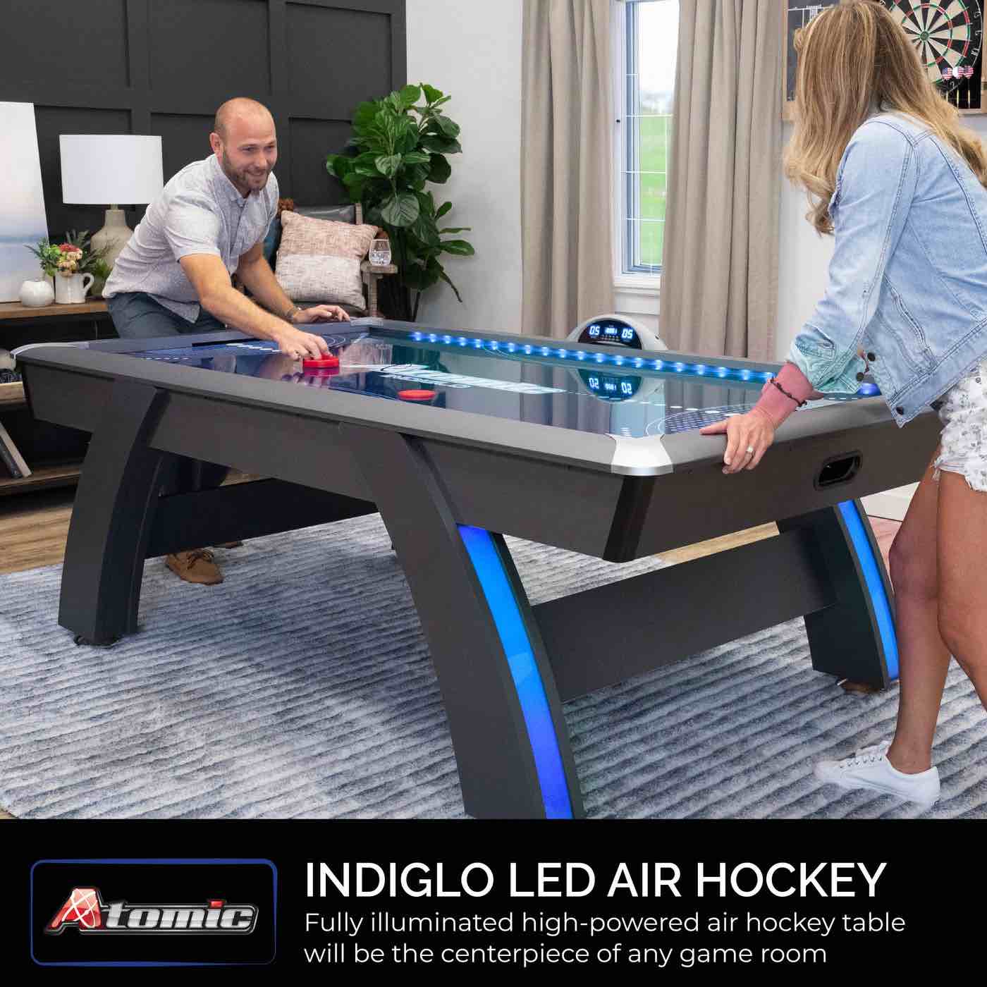 Condition photo showing New/Like New for 90” atomic indigo light up air hockey table, 2 led light up pushers, 2 led light up hockey pucks, led lighted display, lighted legs, tabletop dimensions 81.25” x 41.25”