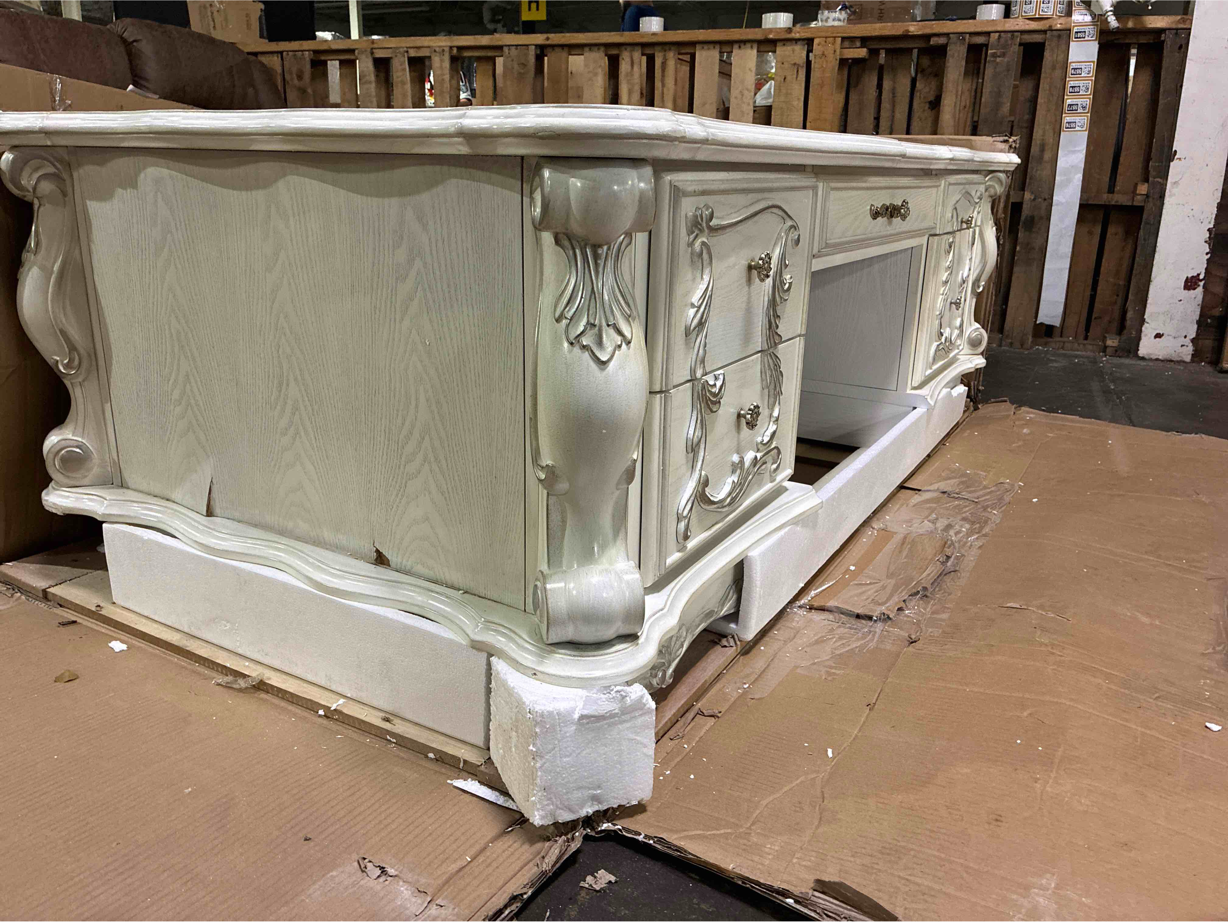 Condition photo showing Good Condition for Acme Dresden Bone White Executive Writing Desk with 5 Drawers, Hand Carved Embellishments, Antique Style Metal Handles, and Claw Feet. Some chipping along left side, otherwise beautiful condition. 31"h x 72"w x 36"d