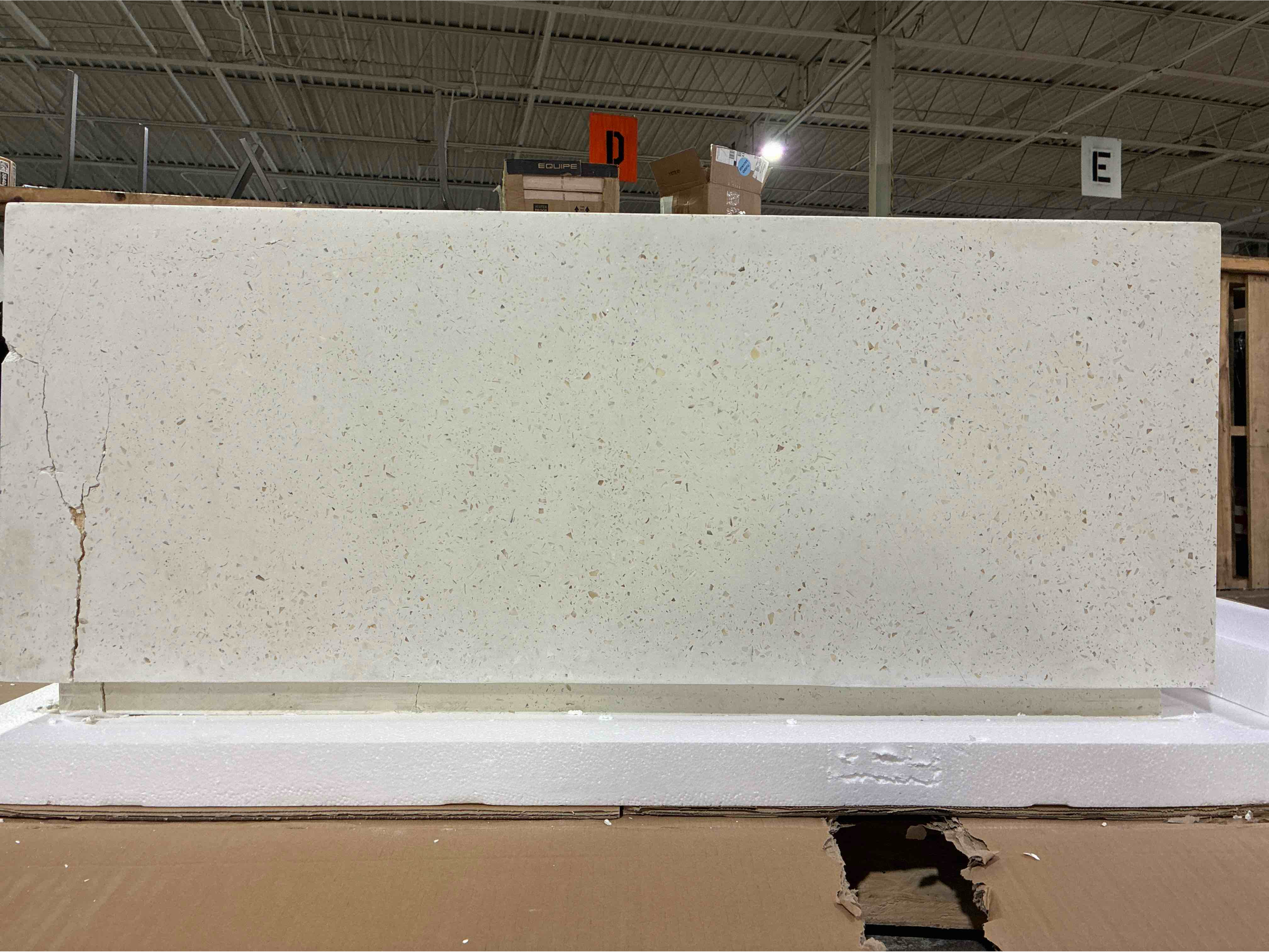 Condition photo showing As Is for urbia mixx concrete style white speckled bloc square coffee table, cracks along edges and some damage to base of side. top is in pristine condition, can be filled in. 47.25"w x 47.25"d x 16.5"h