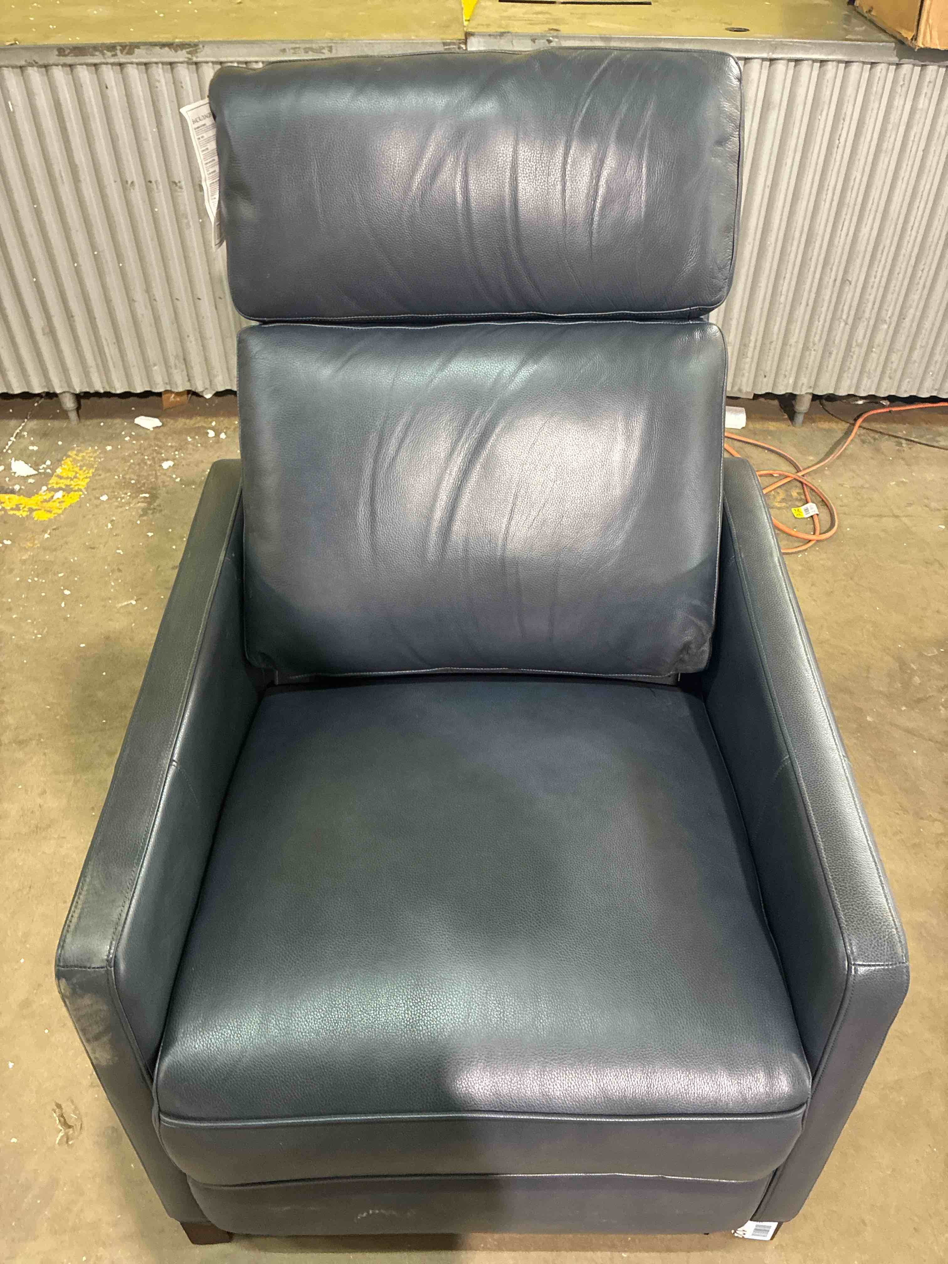 Condition photo showing New/Like New for james navy blue leather full body power recliner with wooden legs. minor chipping on legs, otherwise brand new. d 39.5" w 30.75" h 44" in