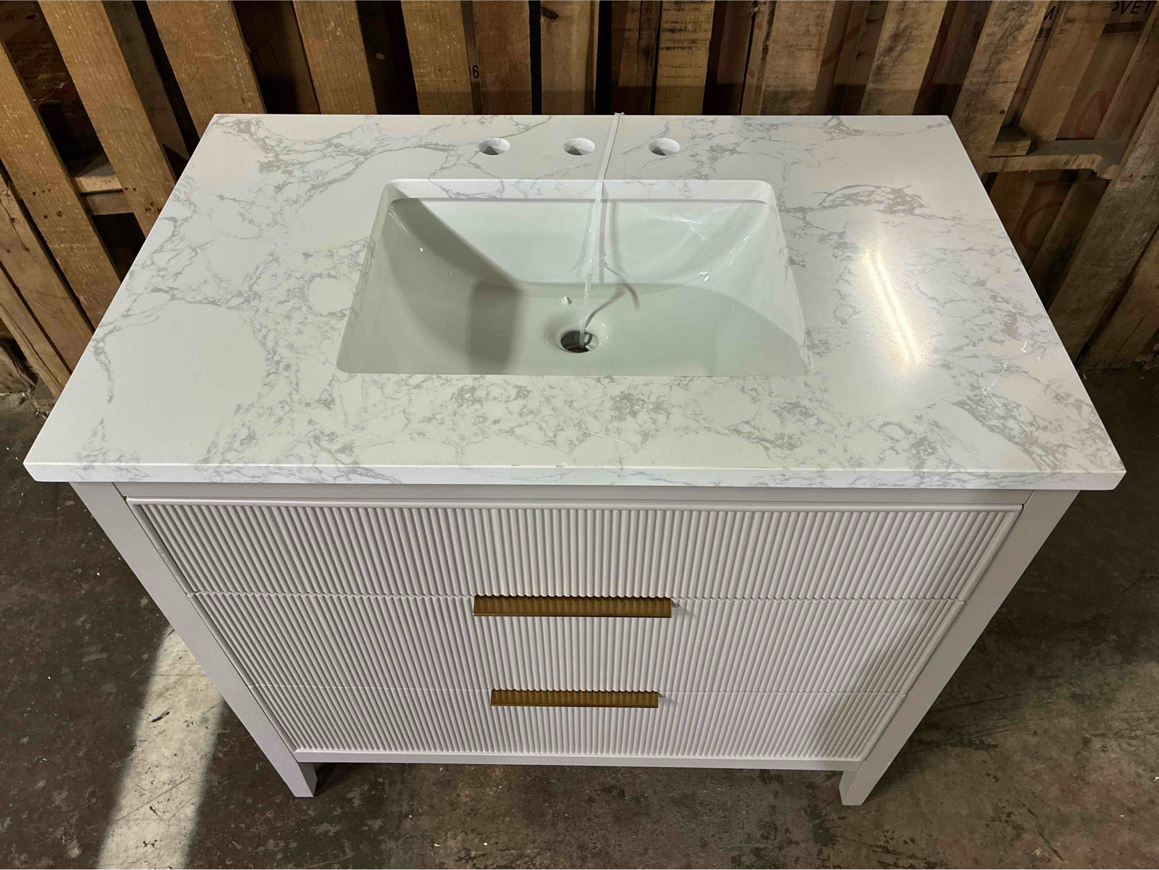 Condition photo showing Good Condition for emma 36 in. w taupe grey single bath vanity sink with 2 drawers, gold brushed handles, and arabescato stone top. some scratches along the top, minor chip on top edge. product depth (in.) 22.00 in product height (in.) 34 in product width (in.) 36 in