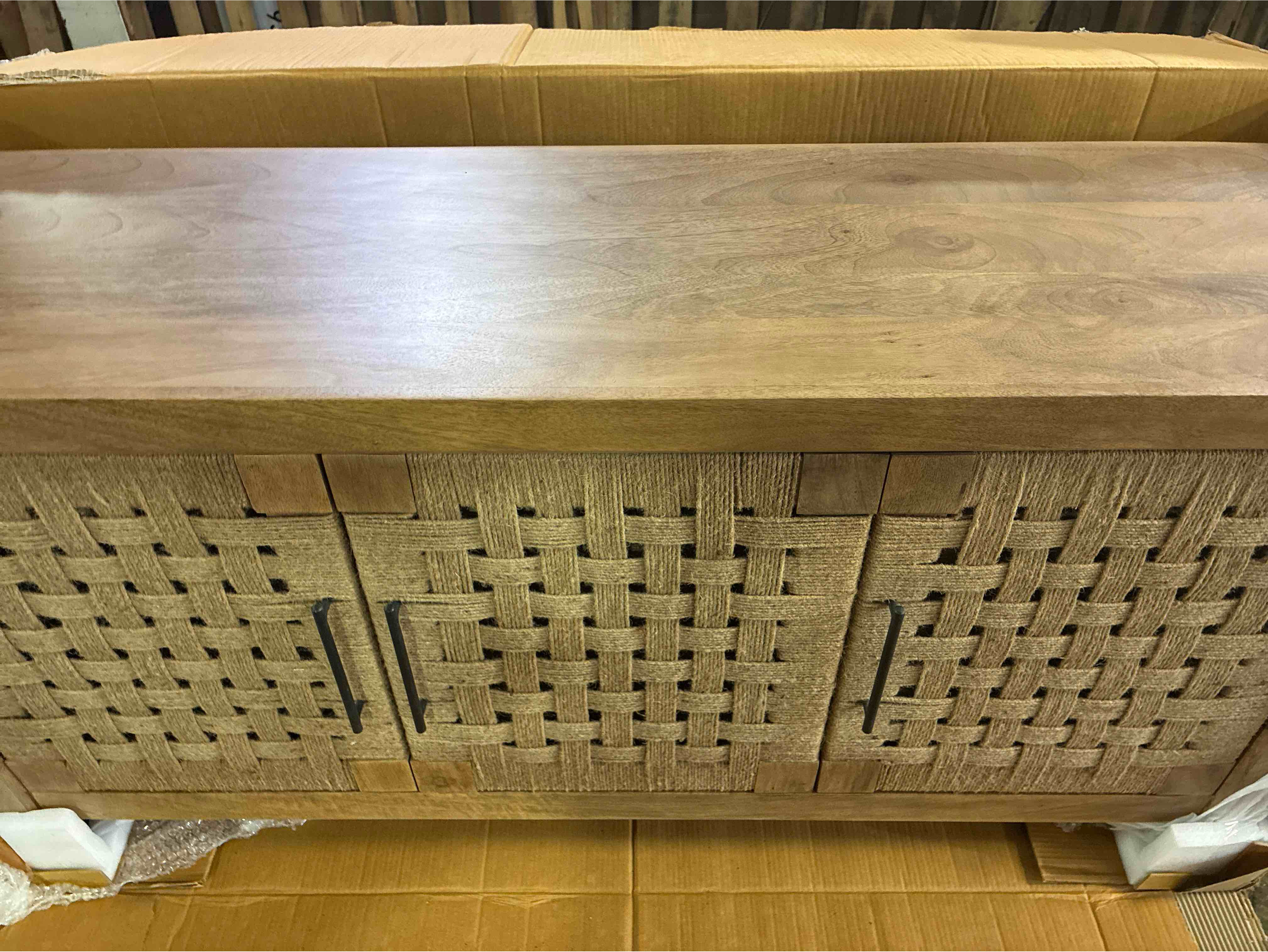 Condition photo showing New/Like New for jayma 57'' mango wood 3 door sideboard with twine woven door panels, single shelf, and matte black handles. 28.5'' h x 57'' w x 16.5'' d