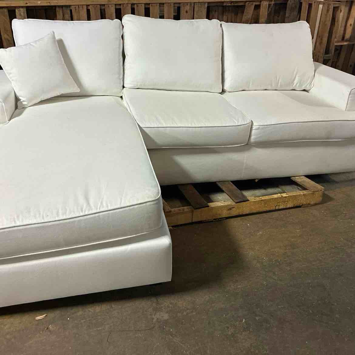 Condition photo showing As Is for alden 100'' white linen upholstered 3 seat l shaped sectional with convertible chaise and black feet. right upper foot needs replaced, right arm needs repair, some marks along edging. 37.4'' h x 100'' w x 67'' d