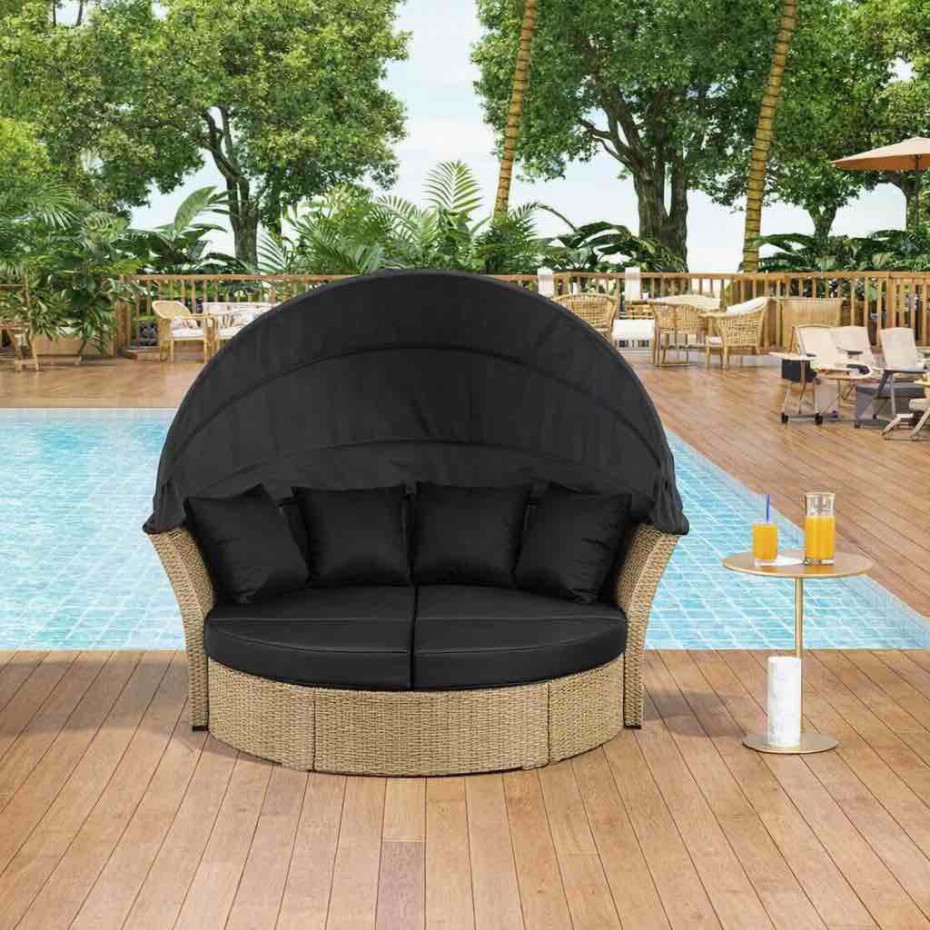 Condition photo showing New/Like New for blonde wicker rattan outdoor double daybed with retractable canopy and black cushions. 65 l x 60.5 w x 54.5 h
