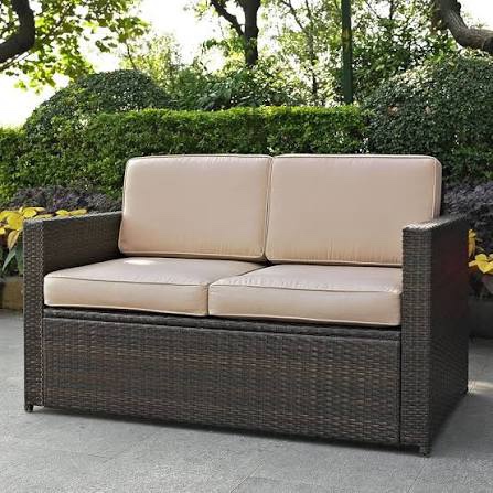 Ocean Vista 2 Seat Rattan Wicker Sofa in Espresso with Small Square Glass Top Coffee Table and Sand Beige Cushions.