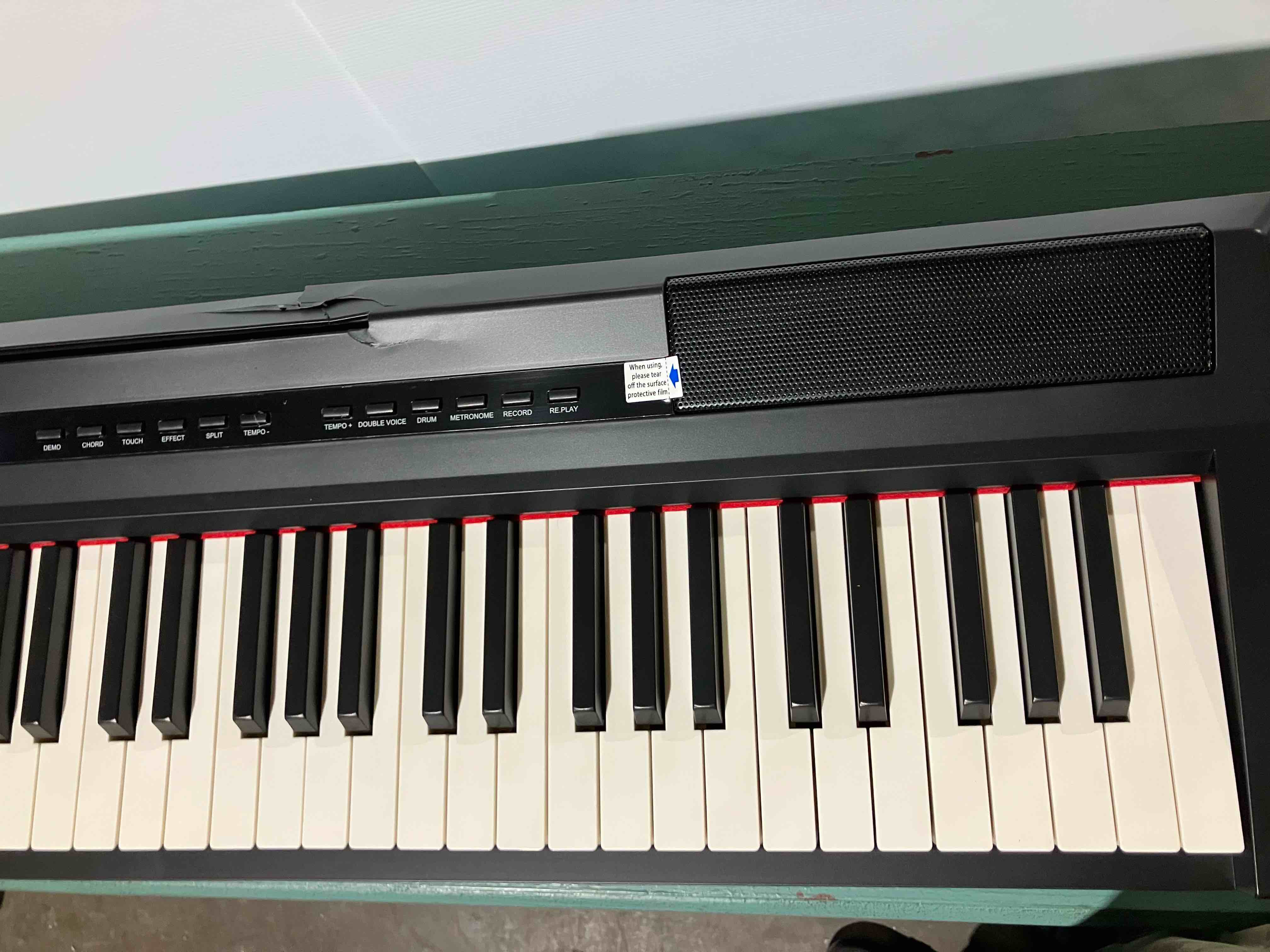 Condition photo showing Good Condition for Donner DEP-20 Beginner Digital Piano 88 Key Full Size Weighted Keyboard, Portable with Furniture Stand, 3-Pedal Unit - (damage to left side of stand, damage to back of piano, does not affect function)