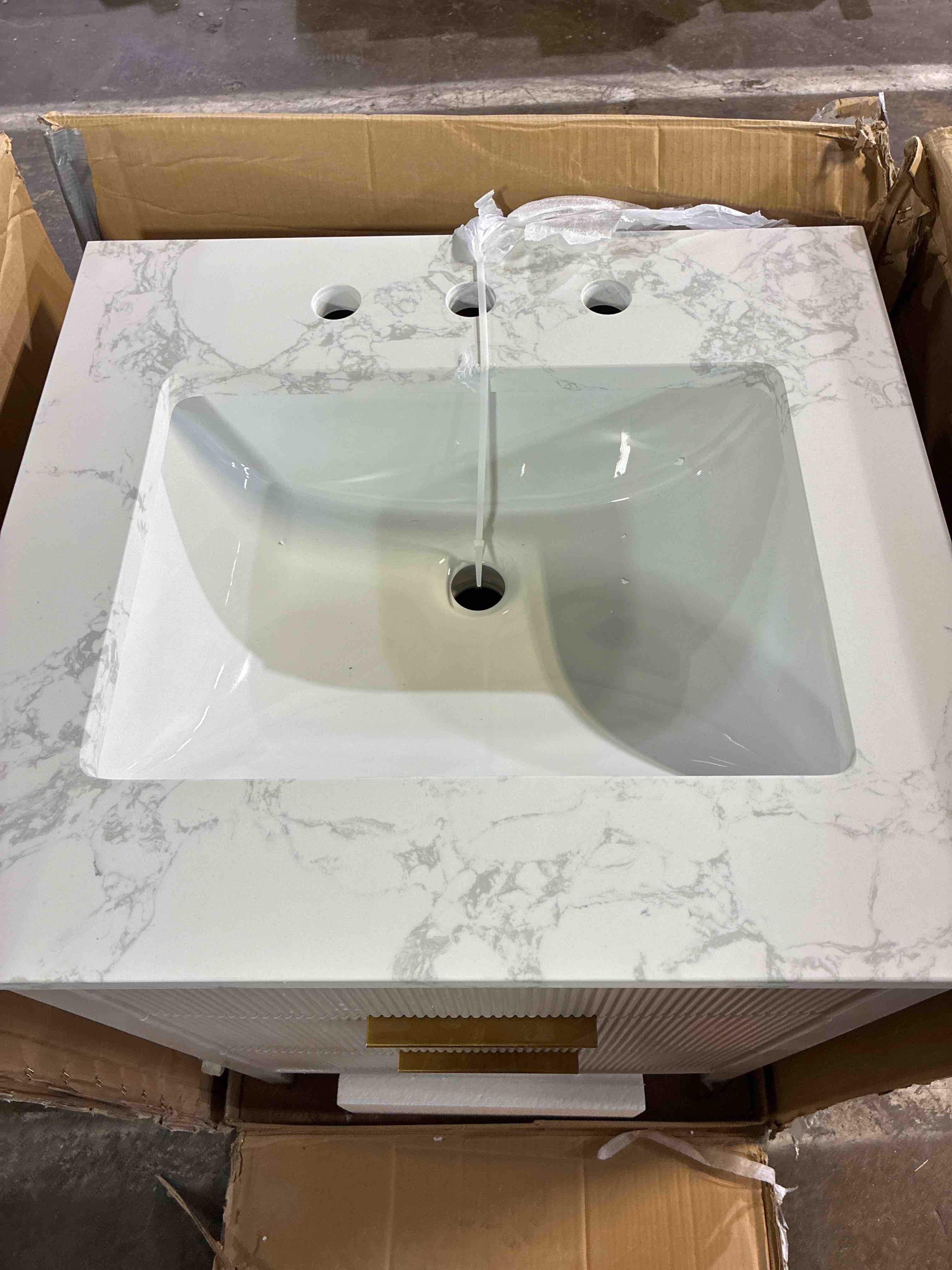 Condition photo showing New/Like New for Emma 24 in. W Taupe Single Bath Vanity with Arabescato Stone Top and Gold Brushed Handles. Botton handle needs glued back on, otherwise brand new. 24 in. W x 22 in. D x 34 in. H