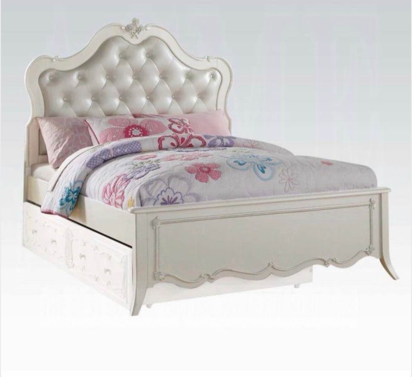 edalene upholstered full bed in pearl white, upholstered headboard with button tufted accents, floral decorative carvings, side rails have some chipping on the corners(pictured),  footboards leg is broken on one side (piece is in box) and cracked on the other(pictured), trundle sold separately, 3 boxes total