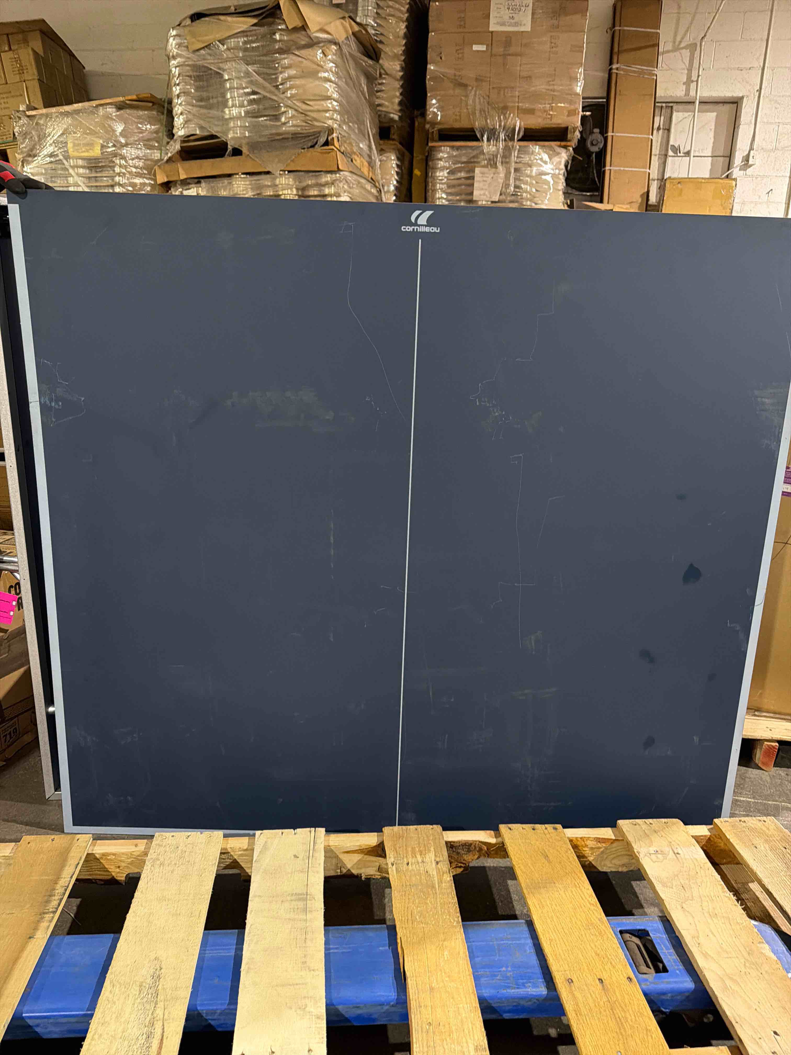 Condition photo showing As Is for sport 500 indoor blue ping pong table, frame 50mm thick, assembly is required, directions available with table, item is as is because scuff marks on tabletop and plastic pieces have scratches on them(pictured),  too many pieces to verify that everything is here, (all abailable pieces are pictured)