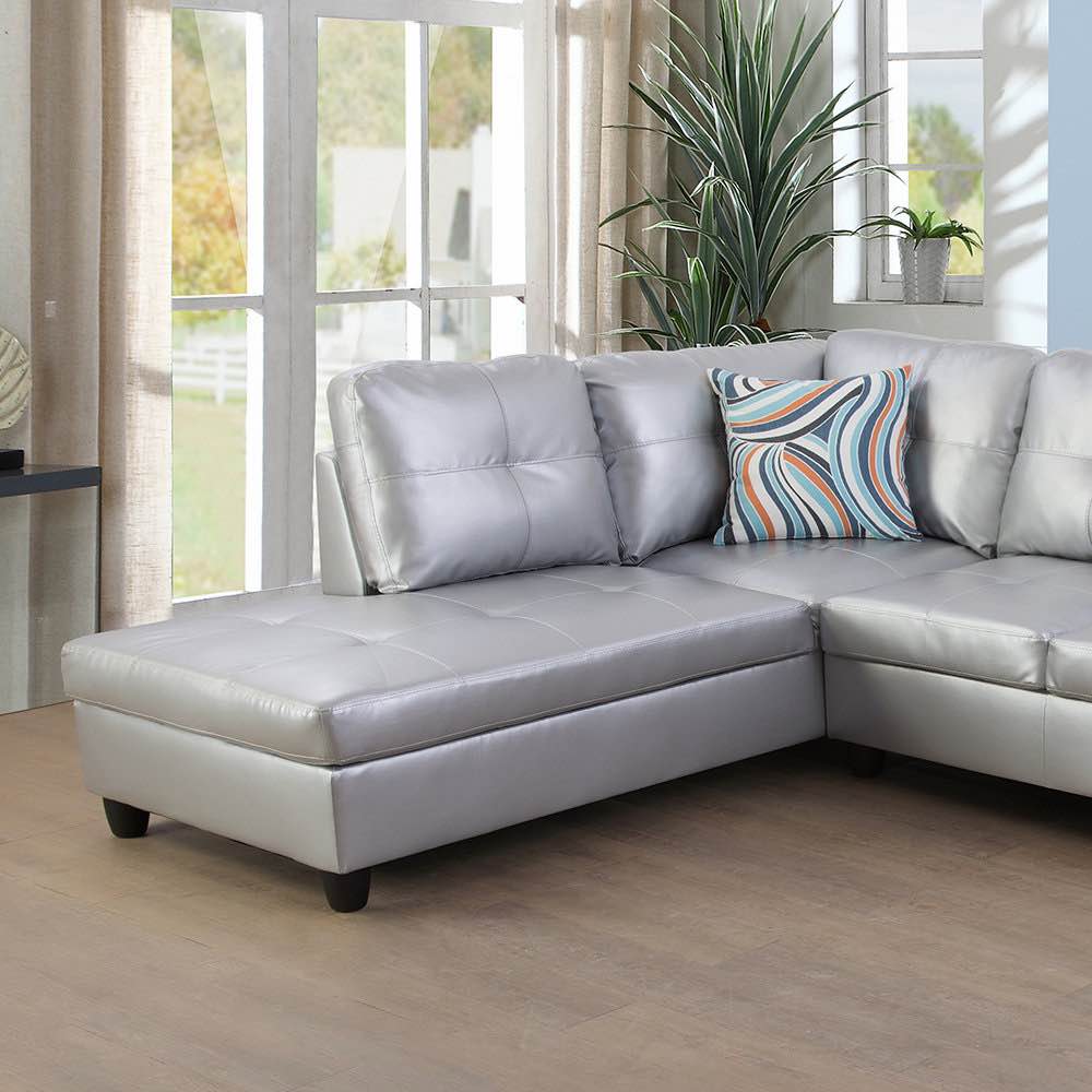 Condition photo showing Good Condition for delacourt 103.5" wide silver faux leather sofa & chaise with 2 decorative throw pillows and black legs, overall dimensions 35'' h x 103.5'' w x 74.5'' d, a few very small fabric scuffs around the bottom of the left side piece(pictured), very small fabric tear on the back of the left side piece (pictured), small fabric scuff on left side back attachment(end piece covers completely when attached), fabric tear front right side corner(pictured)  2 boxes total