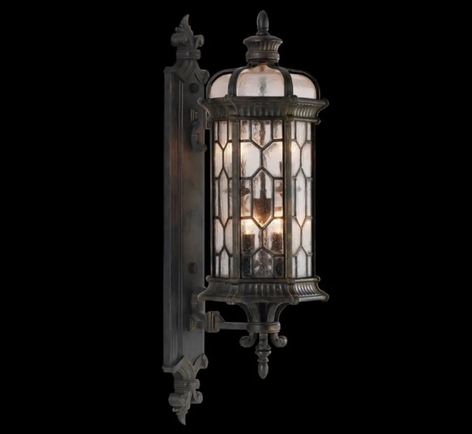 DEVONSHIRE 23" H Antique Outdoor Wall Mounted Light in Antique Bronze with Gold Brushed Accents, Seeded Glass, Old English Panels. 23H x 8W x 10D. A 19, 60W, Medium Bulb Lights Not Included. 