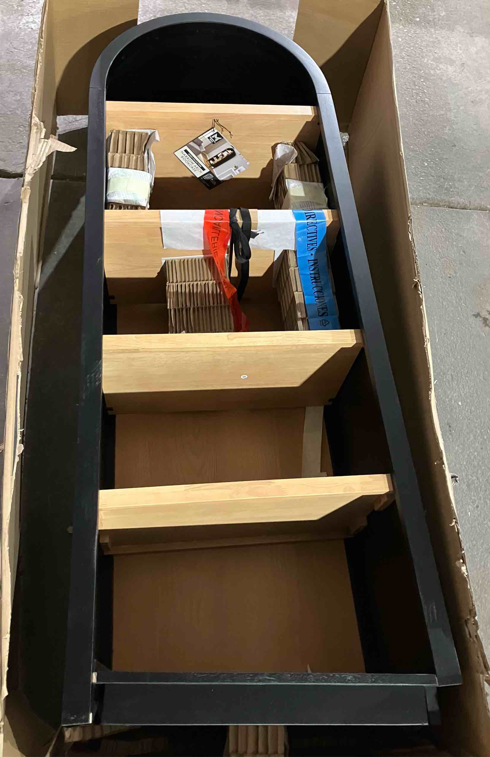 Condition photo showing As Is for Member's Mark Enzo Narrow Arch Bookcase with Shelves - (As is because bottom/base is broken/bent, will not stand without repair)