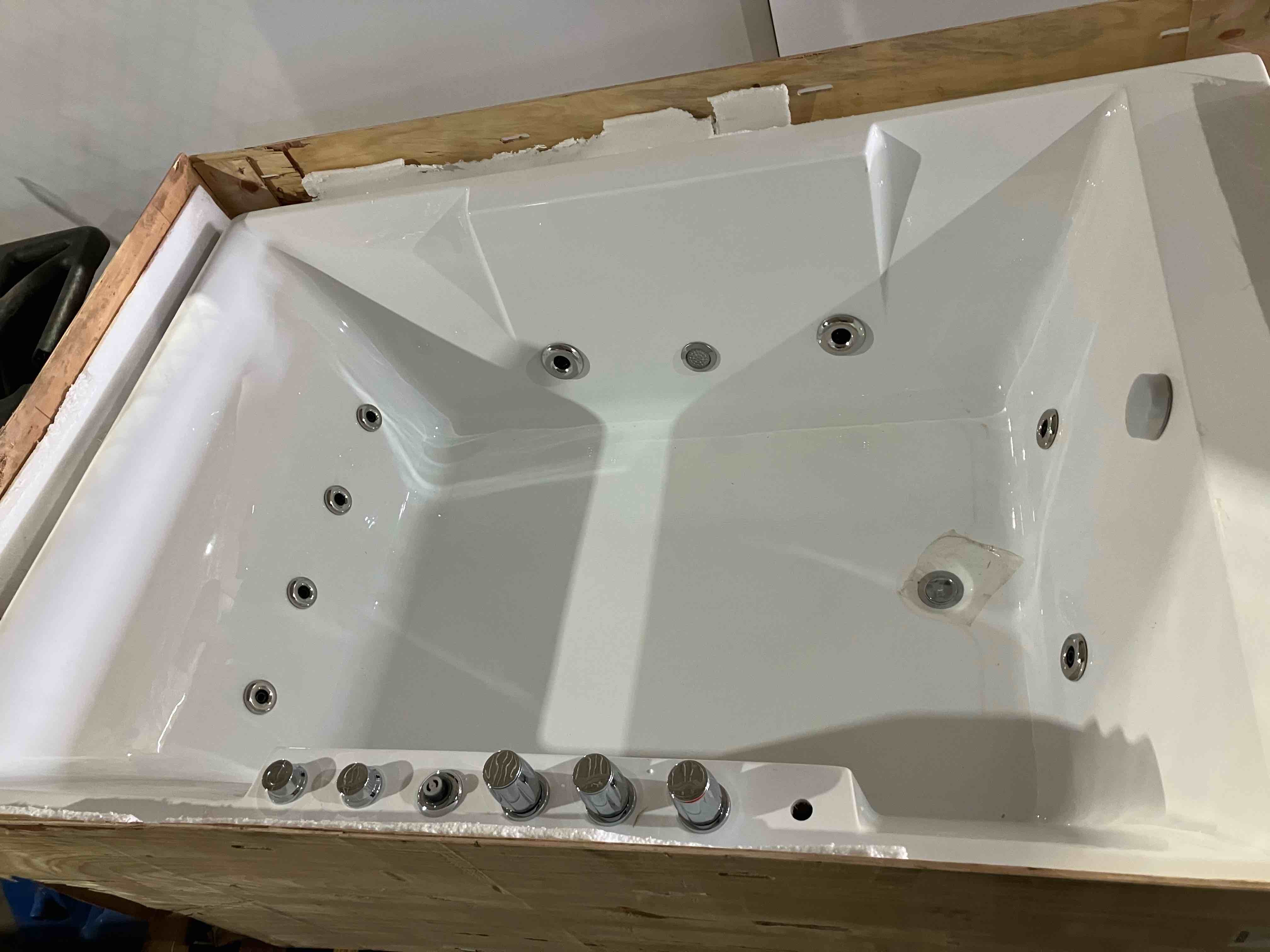 Condition photo showing As Is for 72-Inch Whirlpool Jetted Tub, Acrylic Hydro Massage Bathtub with 10 Jets, Alcove, Color-Changing LED Lights, 2-Person Jetted Bath Tub for Couples - (As is because of a crack in the front right corner of tub, pictured, as well as gouging and cracking to parts of the outer shell/casing panels to tub front/sides of tub, also pictured. There are some scratches other places also)