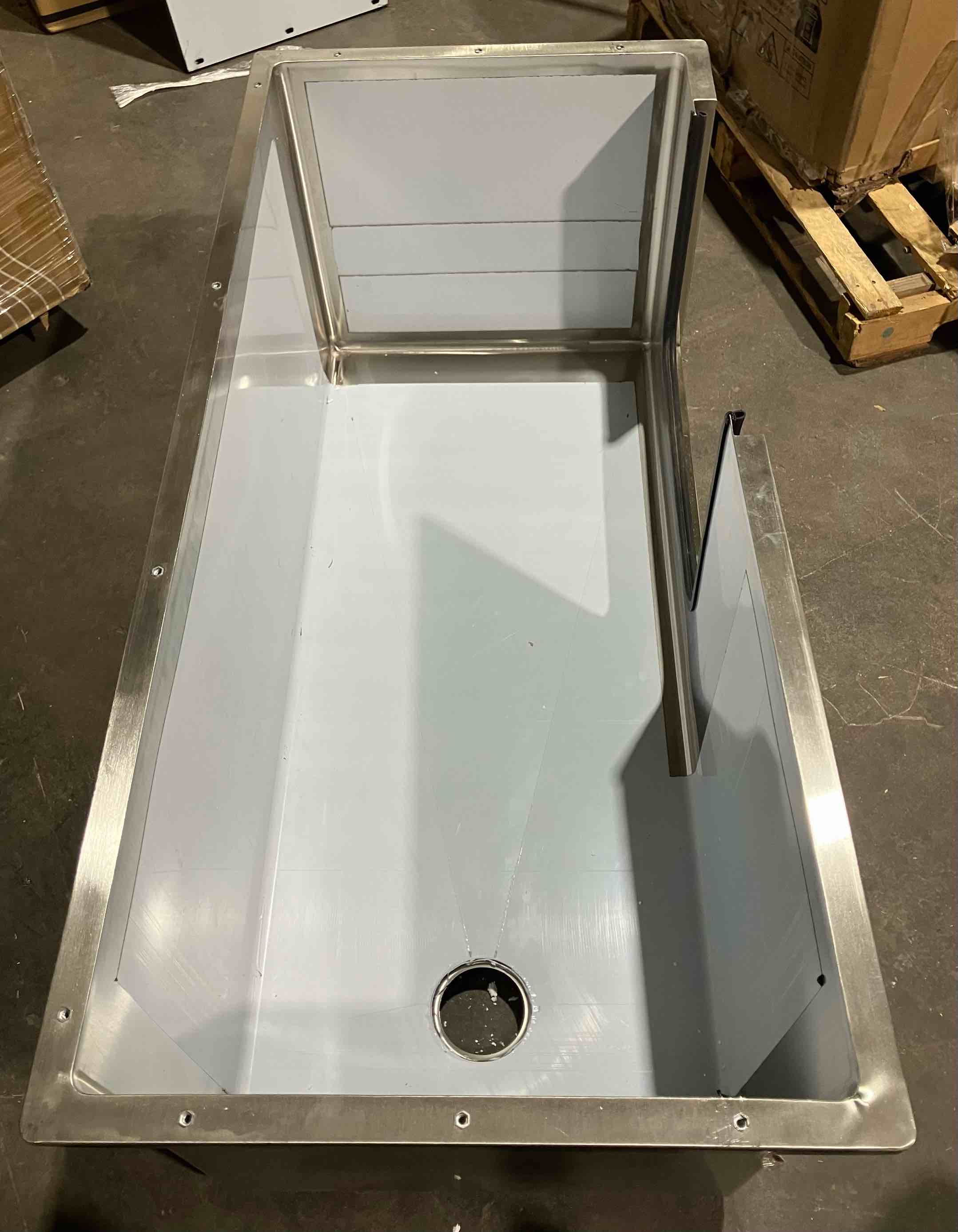 Condition photo showing Good Condition for VEVOR Stainless Steel Dog Washing Station, 50 inch Pet Grooming Tub w/ Ramp, PE Water Filter Board, Faucet & Showerhead & Soap Holder Dog Bathtub for Large & Medium & Small Pets (Right Door) - (Good condition because of a slightly bent front side panel, should not affect function. There is also a hole/metal crack in the top front left corner of the tub, pictured, which also should not affect overall function)