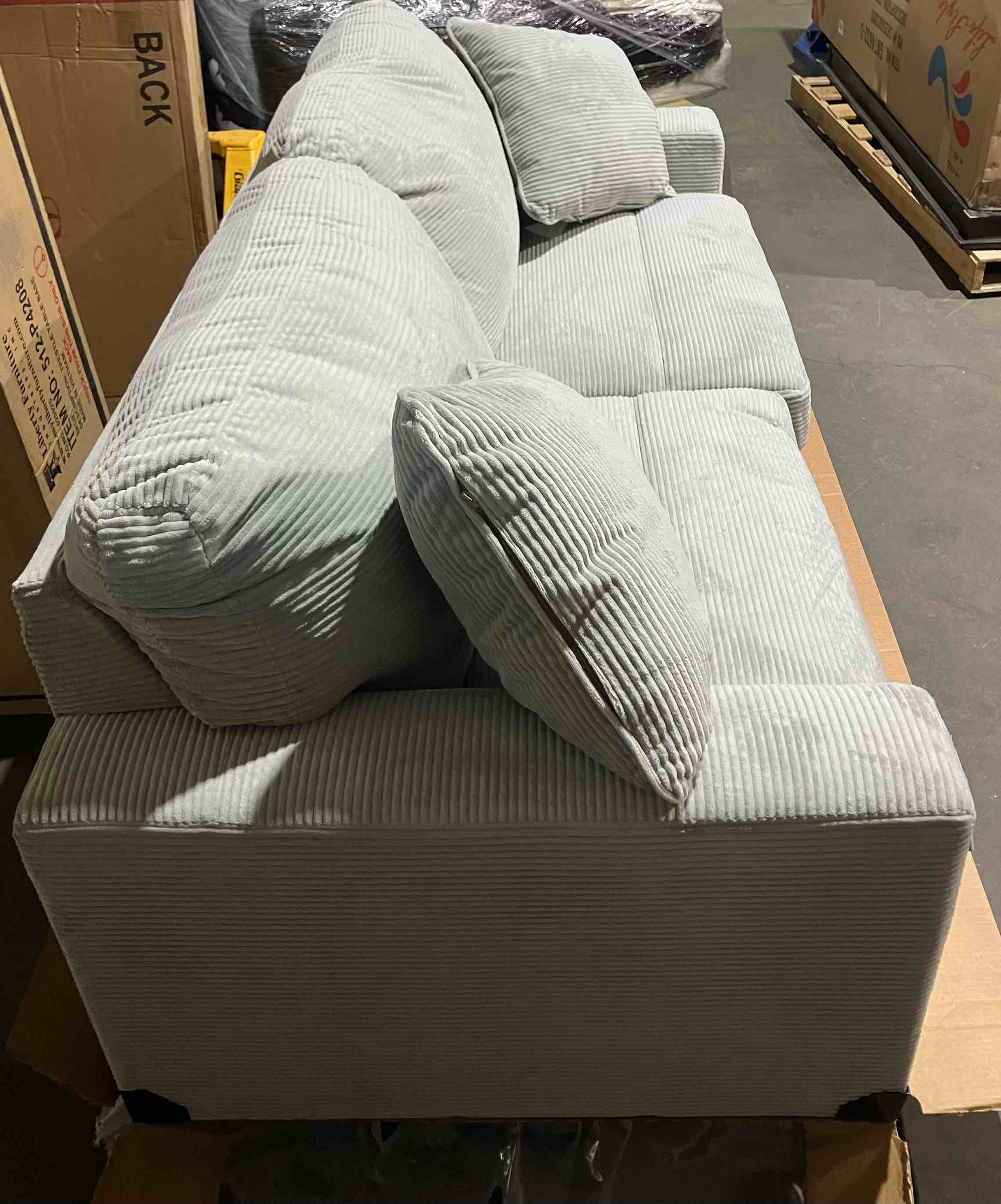 Condition photo showing New/Like New for Amesley Sofa by Ashley Signature Furniture in Textured Smoke Gray 