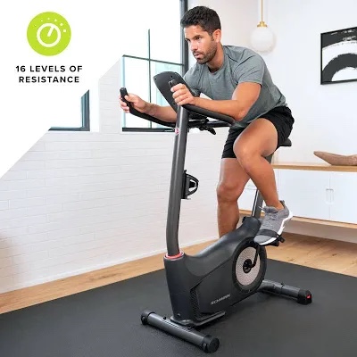Schwinn Fitness 130 Upright Exercise Bike, 5" LCD display features 13 workout programs, goal tracking, and fitness metrics + 16 Levels of Resistance