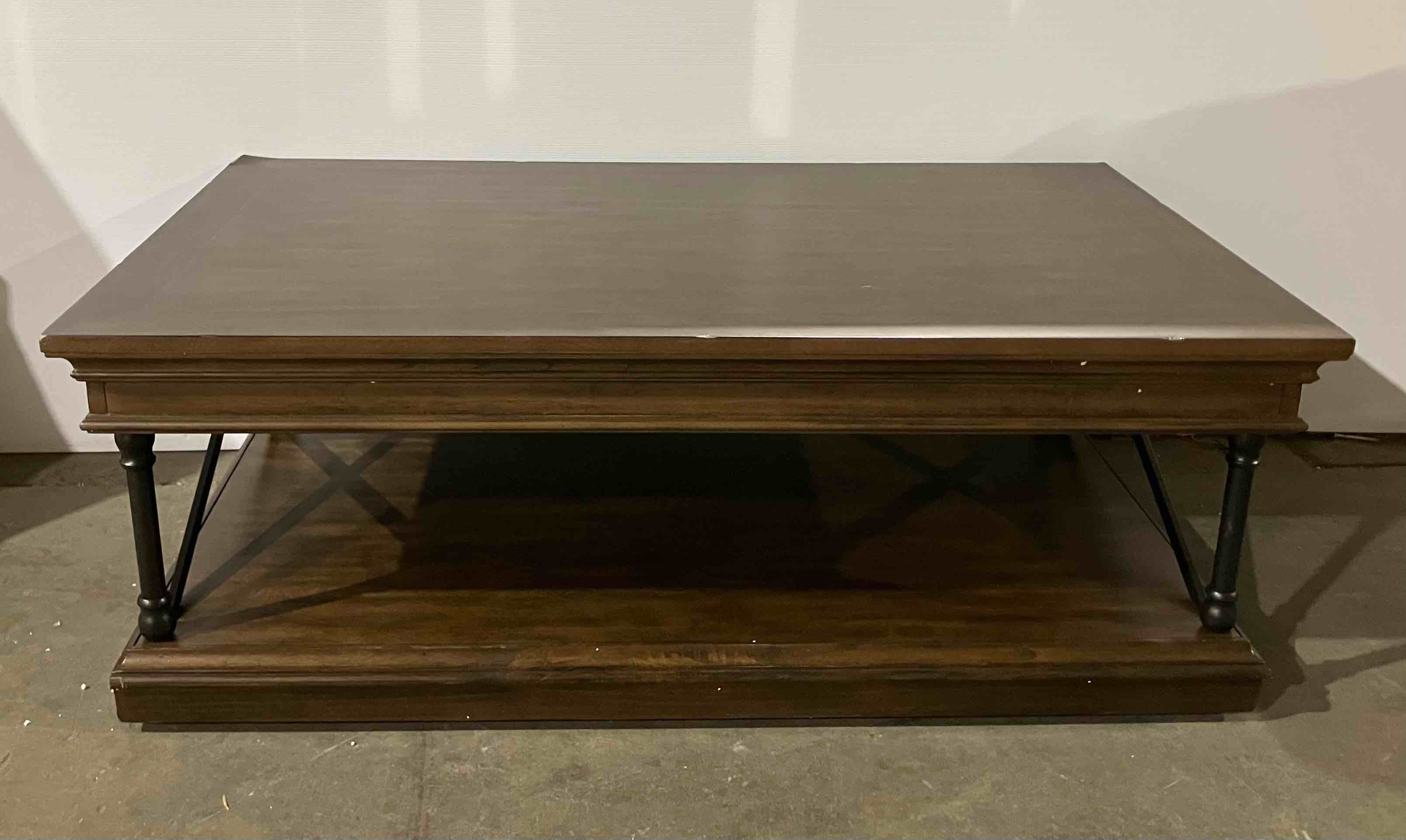 Condition photo showing Good Condition for Abigaelle Molena Rectangular Cocktail Table w/ Storage and Casters - 18'' H X 50'' W X 30'' D - (good condition because of damage to corner of table, pictured)