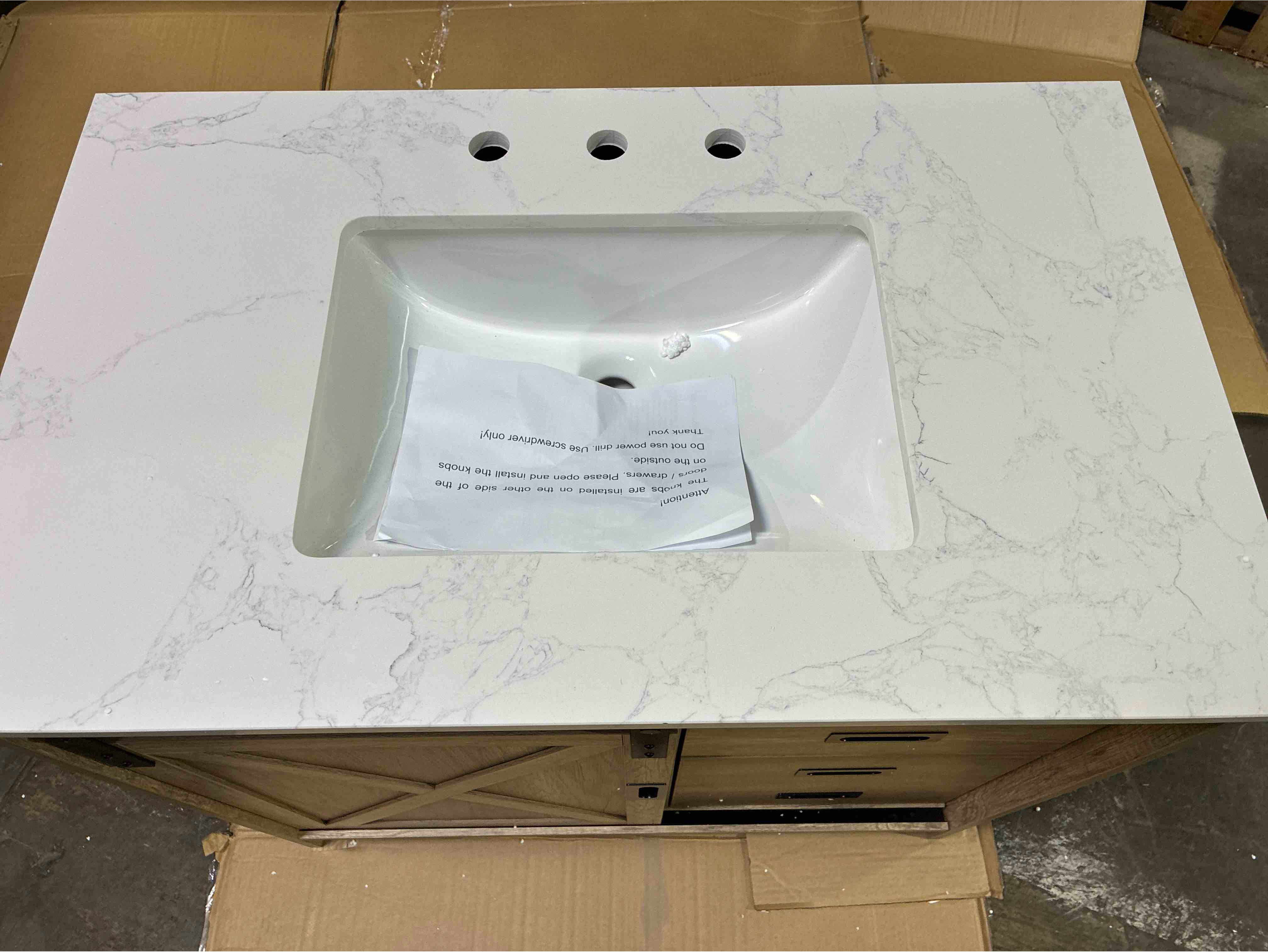 Condition photo showing New/Like New for Boden Natural Oak Barn Door Style 36 inch Single Sink Bathroom Vanity with 2 Drawers and 1 Single Shelf Cabinet, Matte Black Metal Handles, White Marble Painted Stone Top. 22'' H X 36'' W X 34'' D