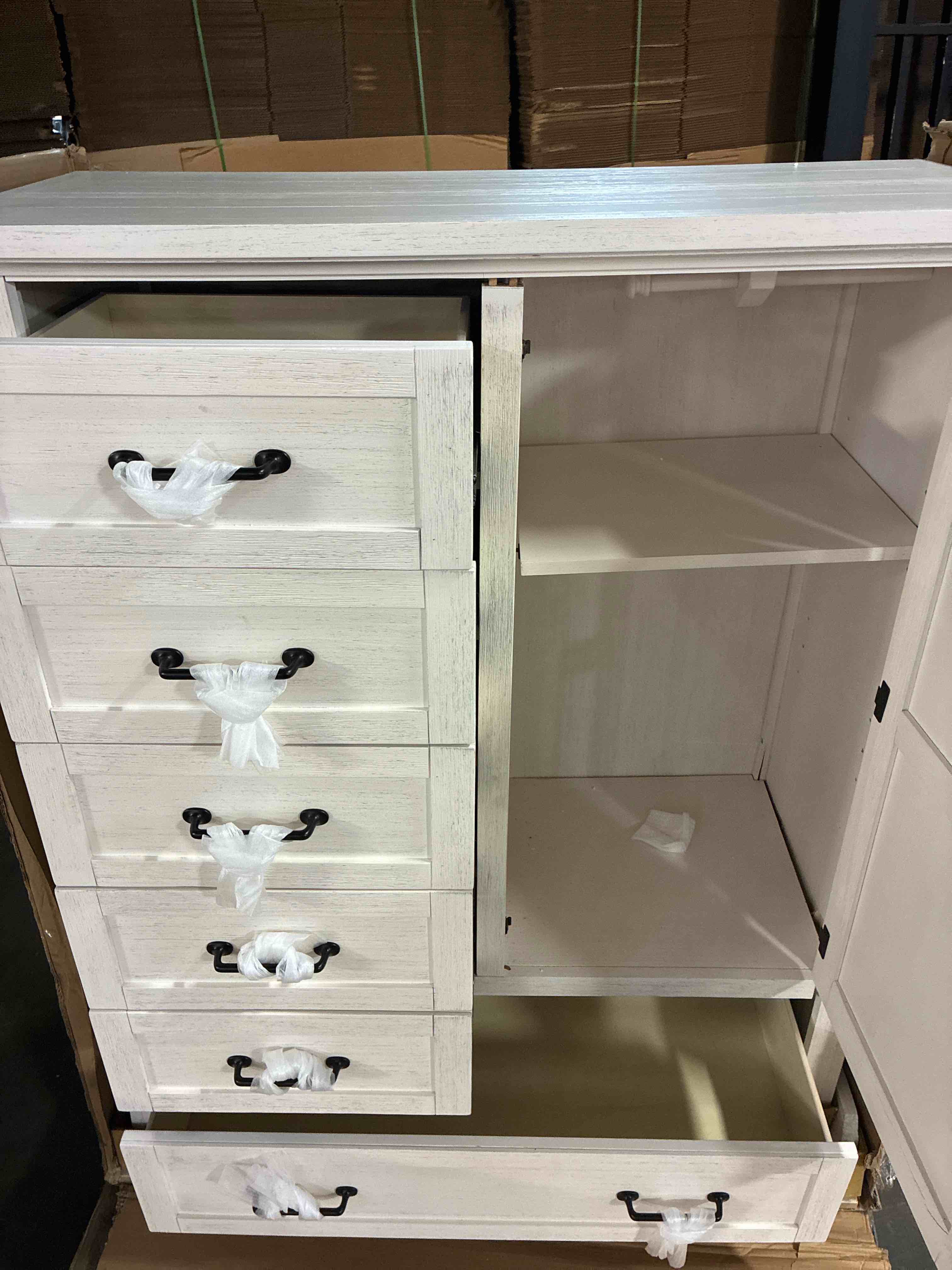 Condition photo showing As Is for Farmhouse White Solid Wood 6-Drawer Chifferobe Dresser Chest, with Black Metal Handles and 1 Adjustable Shelf Cabinet. Buy/Repair Back panel needs replaced, chip along interior back bottom, some pieces of frame need restabilized. With some repair can be quality dresser. 44.01" W × 18.97" D × 55.62" H