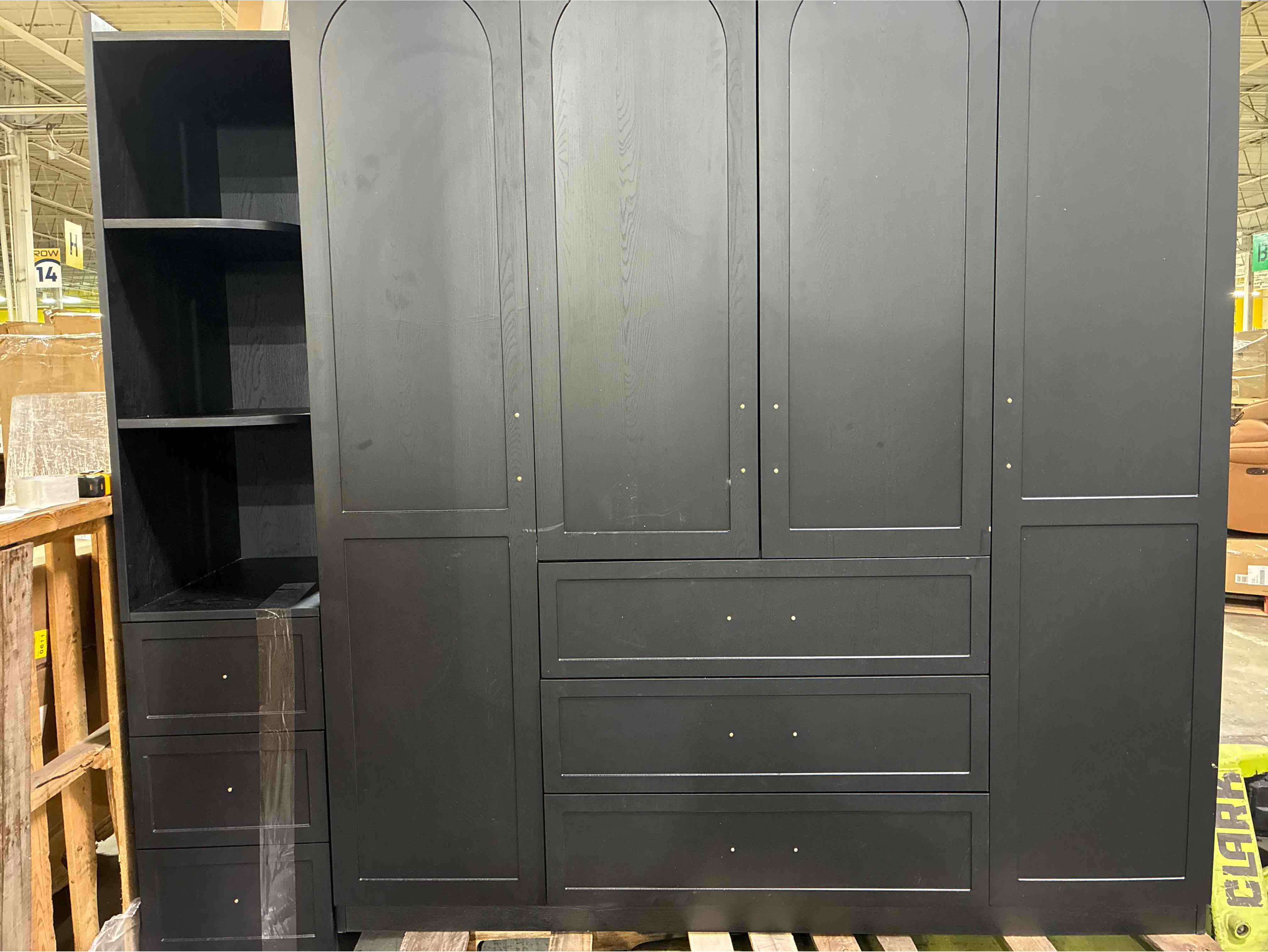 Condition photo showing Good Condition for Luxury Matte Black Wardrobe with 4 Clothing Cabinets, 3 Drawers, and Side Stand for Accessories and Smaller Pieces. Top shelf of accessory stand needs repaired, minor marks on edges of wardrobe, wood crack in back of right hand cabinet, otherwise beautiful condition. 78.74'' H X 94.49'' W X 23.62'' D
