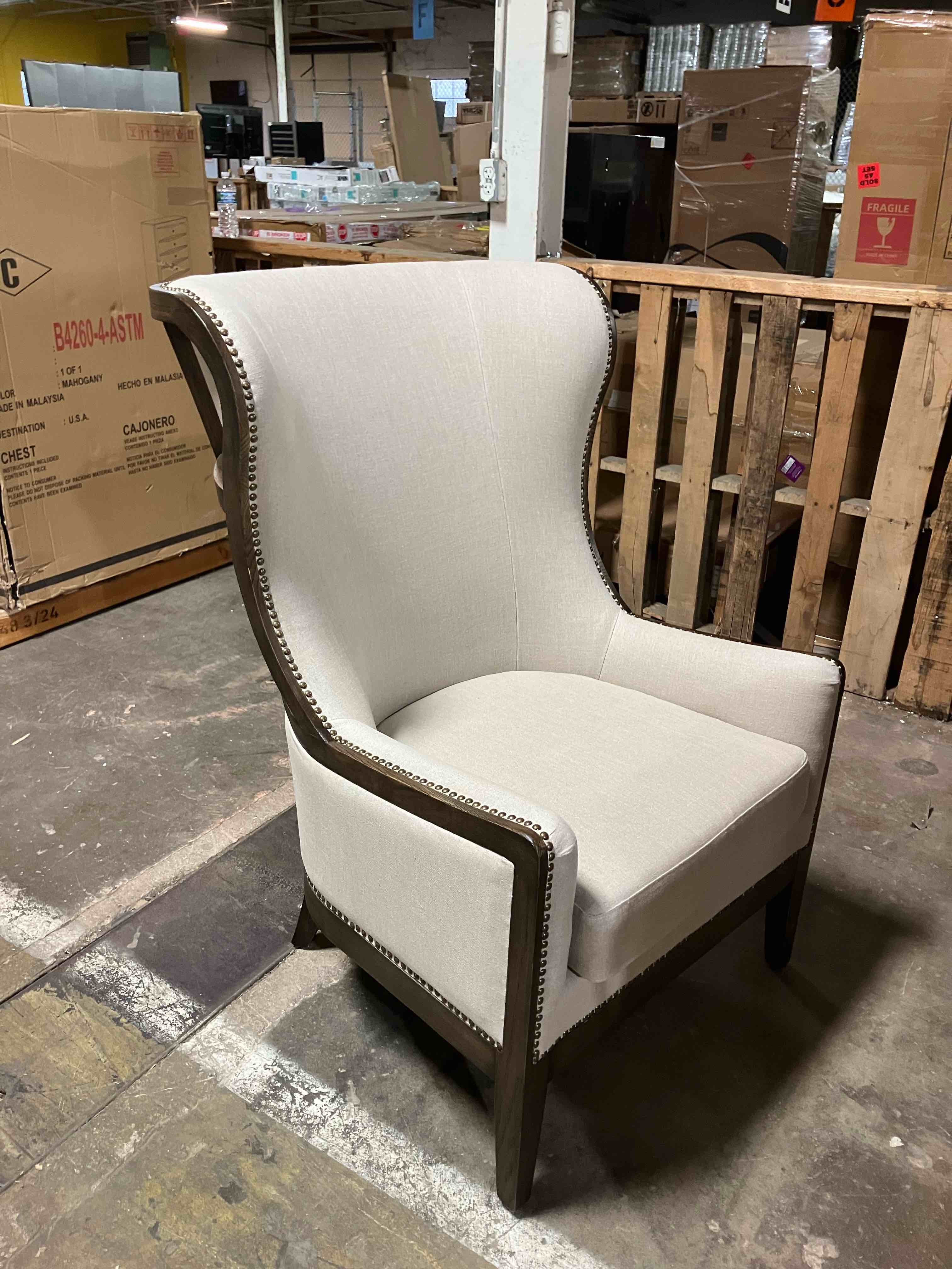 Condition photo showing As Is for Nolan Upholstered Wingback Chair - (As is because top back of chair is damaged, pictured, as well as some scrapes along the edges on the sides and legs, also pictured)