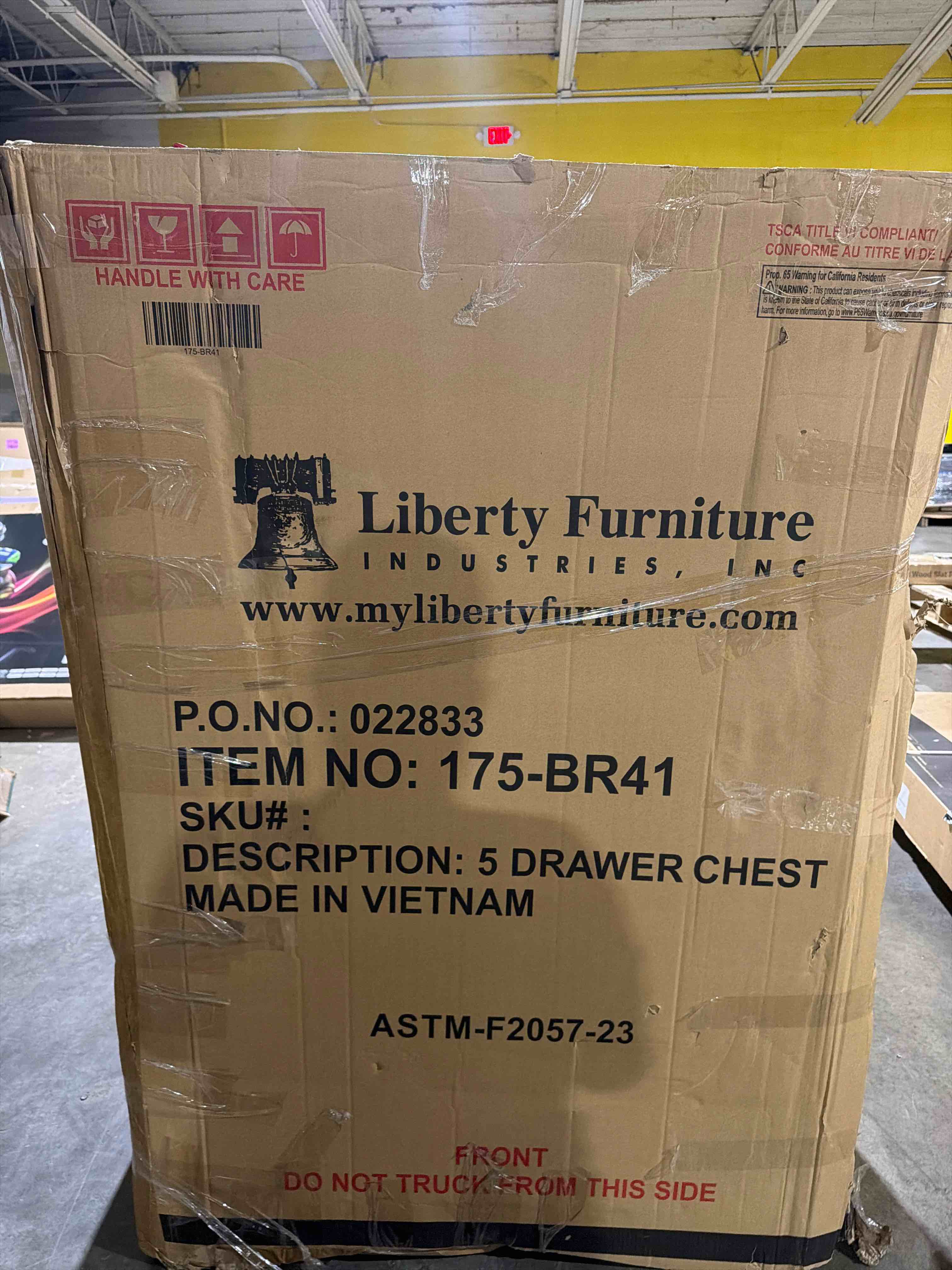 Condition photo showing New/Like New for grandpas cabin 5 drawer chest in a medium brown finish with antique brass knob hardware, box is slightly damaged, (chest is not damaged)