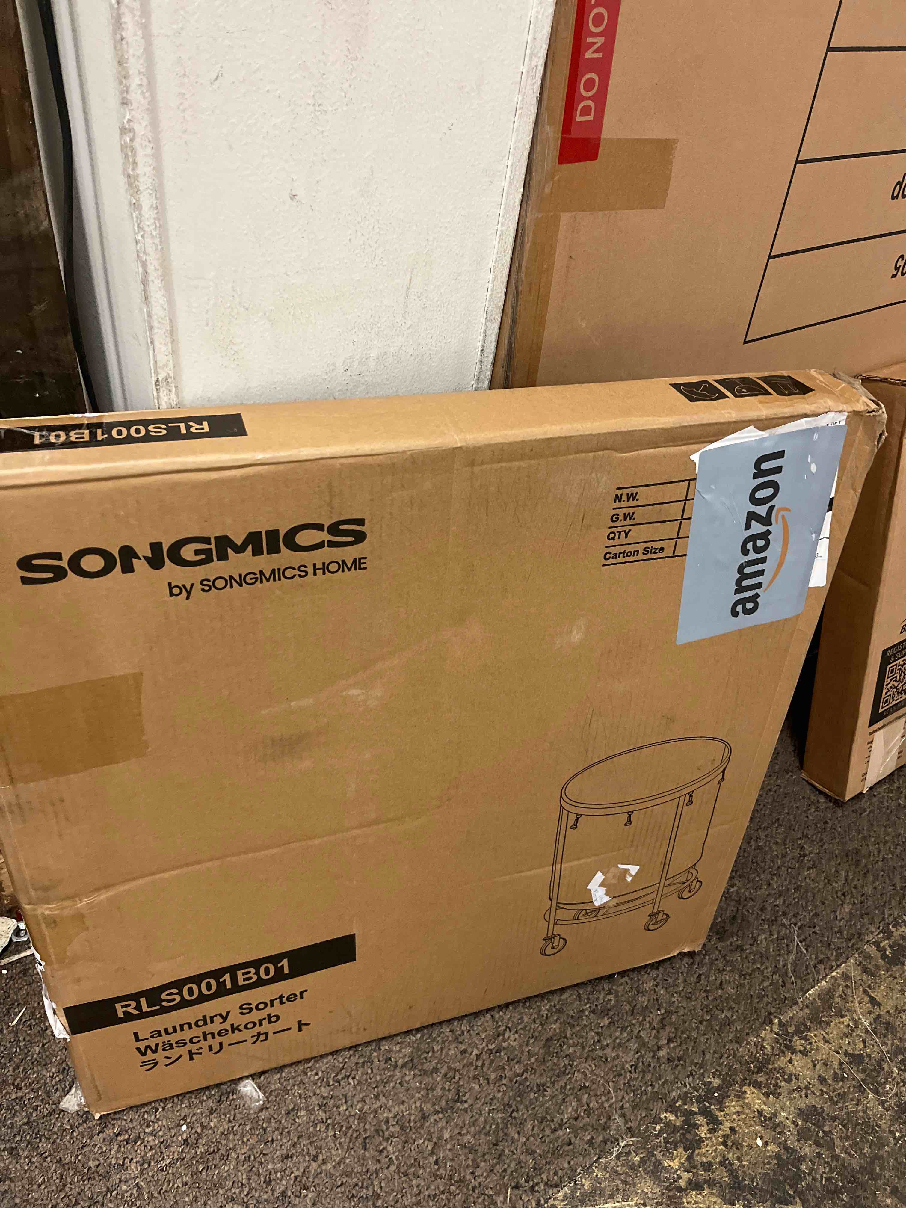 Condition photo showing New/Like New for songmics 50.2-gallon (190 l) laundry basket with wheels, rolling round heavy-duty laundry hamper cart with steel frame and removable bag, 2 locking wheels, ink black and metallic silver urls001b01