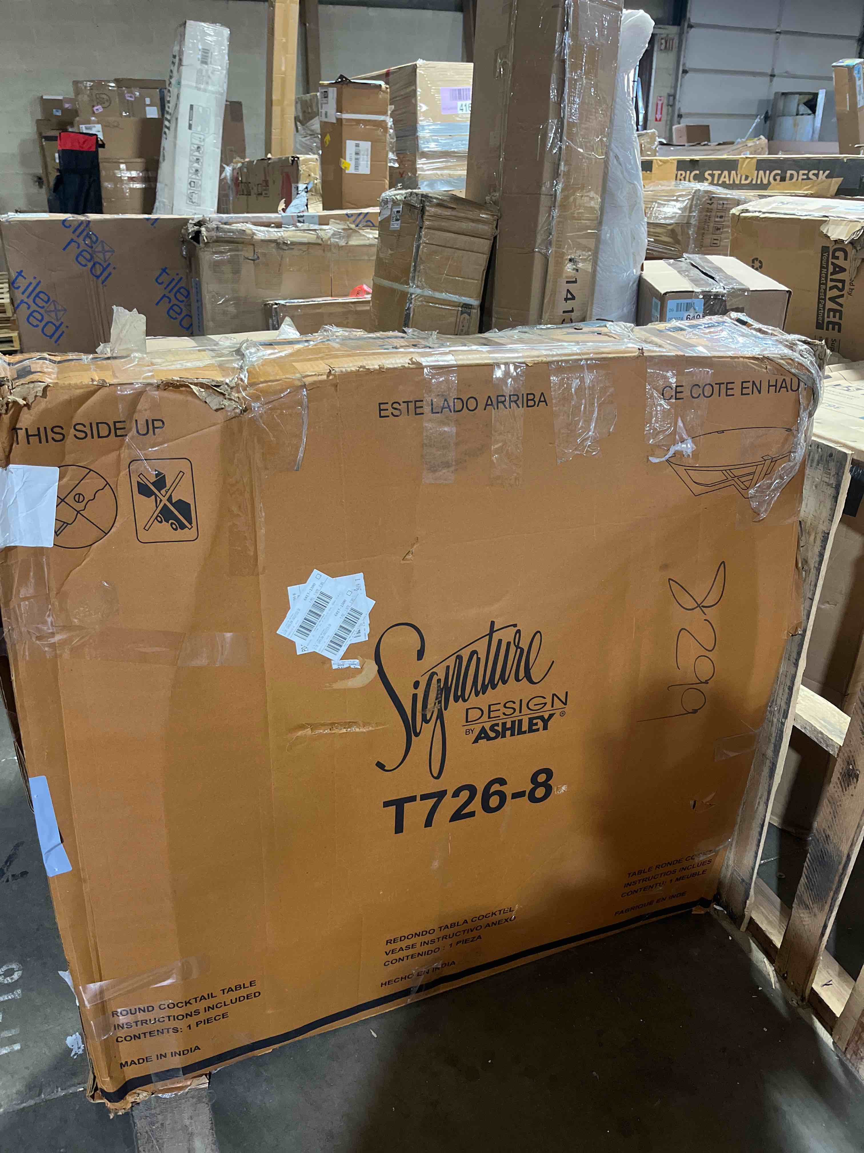 Condition photo showing As Is for Signature Design by Ashley Hanneforth Farmhouse Coffee Table with Angled Solid Wood Legs, Light Brown & Black