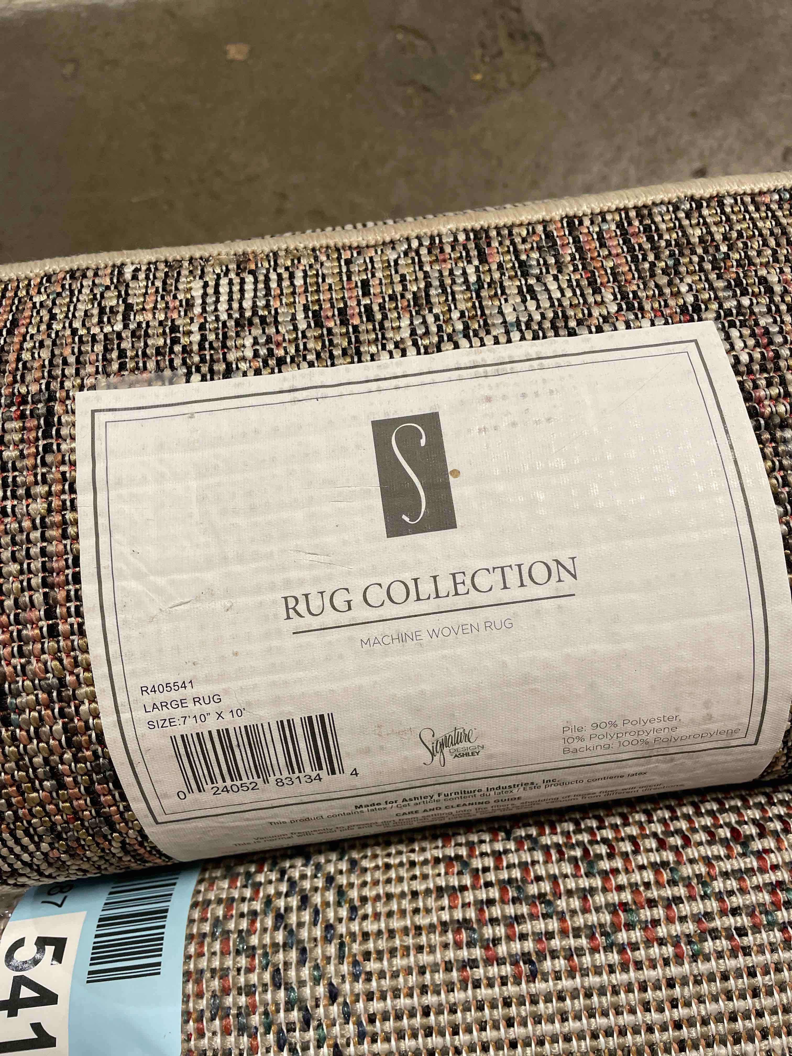 Condition photo showing New/Like New for Signature Design by Ashley Middleburg Contemporary Indoor/Outdoor 8 x 10 Large Rug  Low Pile  Light Brown & Beige
