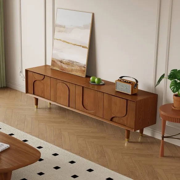 71" Mid Century Walnut Wood TV Stand, Smooth Caramel Finish, Round and Curvy Carvings along Doors, Smooth Top, 4 Cabinet Doors with Magnetic Push, 1 Shelf in Center. Manufacture descrepency, far left door does not fully close, otherwise brand new condition. 70.87'' W X 14.96'' D X 21.06'' H. 