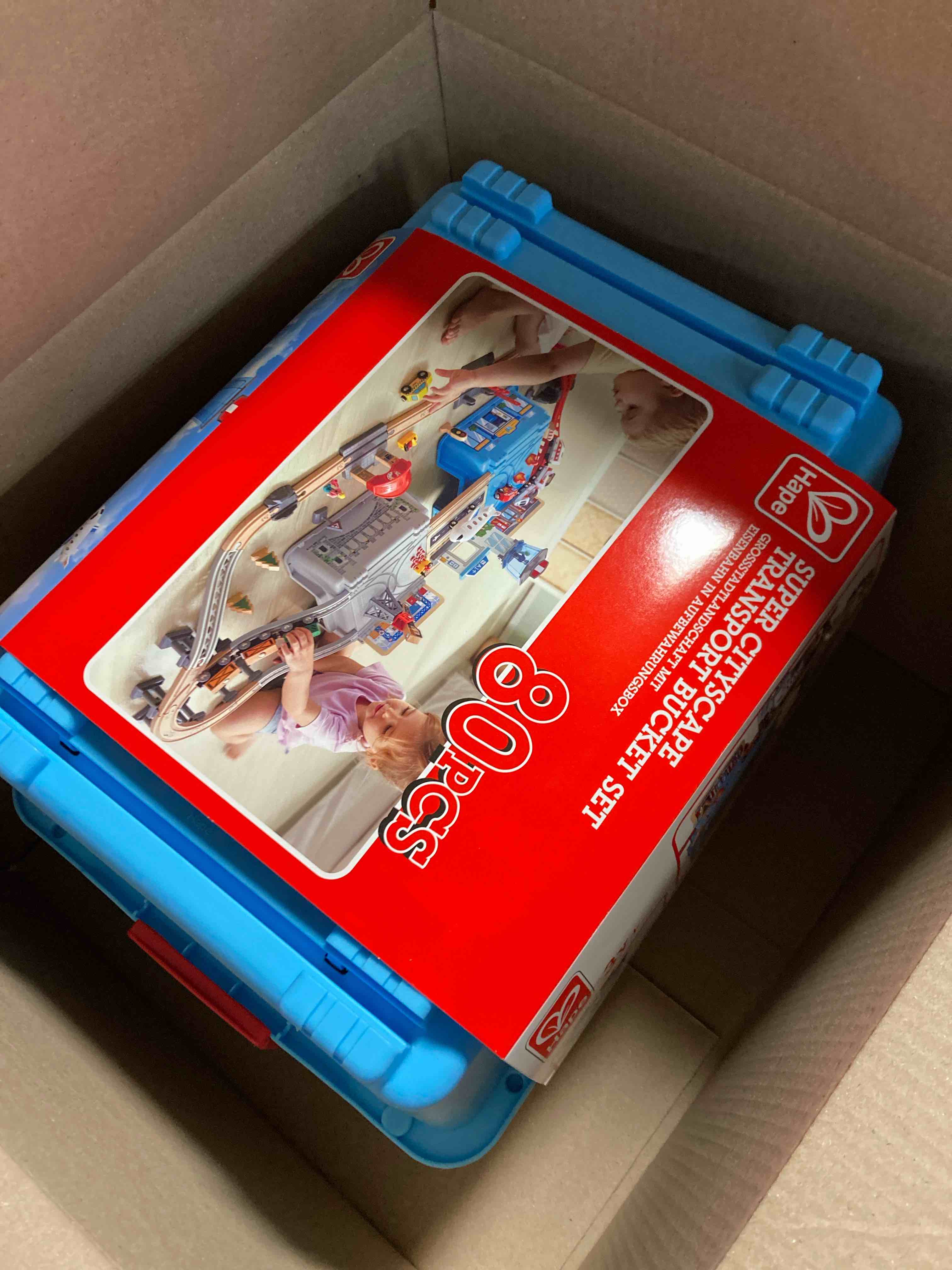 Condition photo showing Brand New for Hape Super Cityscape Transport Bucket Set | Wooden Toy Train Set with City Scenes, Plane, Battery-Powered Engine, for Children 3+ Years