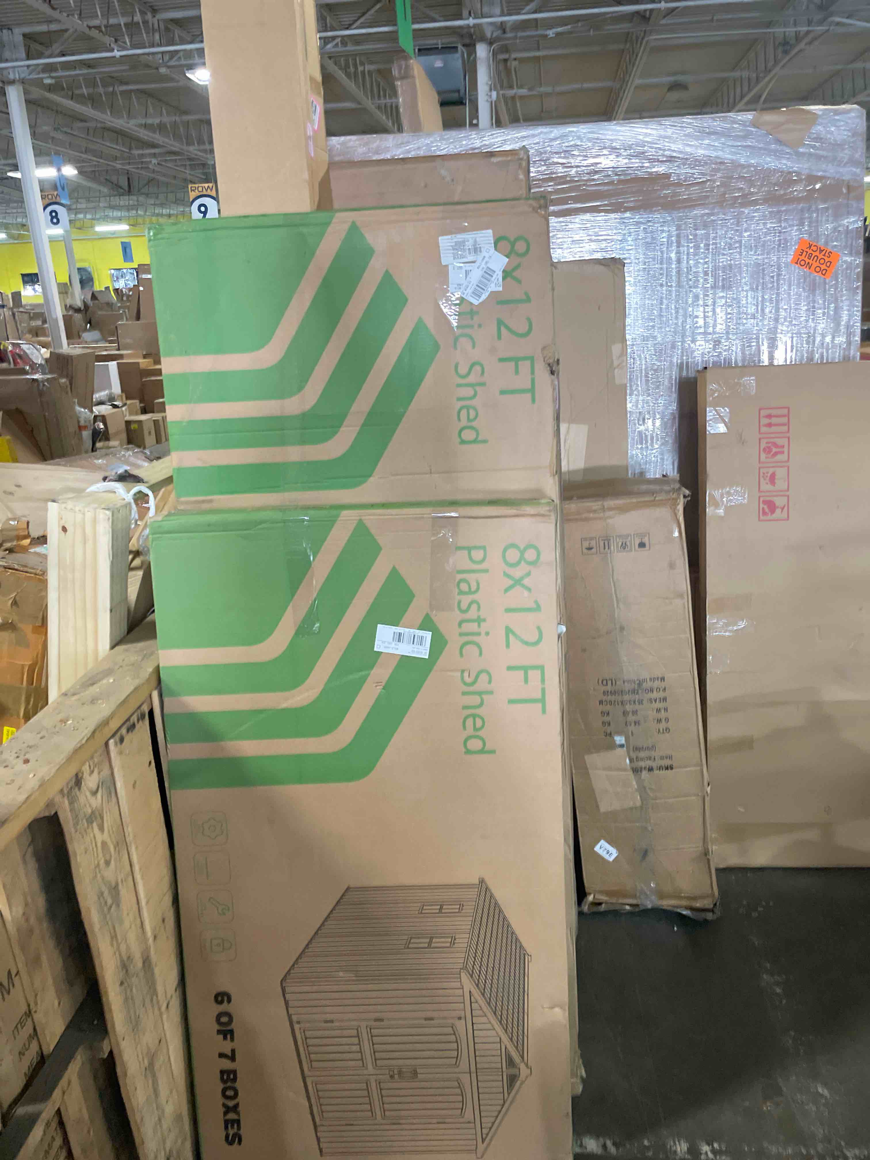 Condition photo showing As Is for lifetime products 8-ft x 12-ft brown gable roof plastic resin storage shed (incomplete box 1/7 and box 6/7 only)