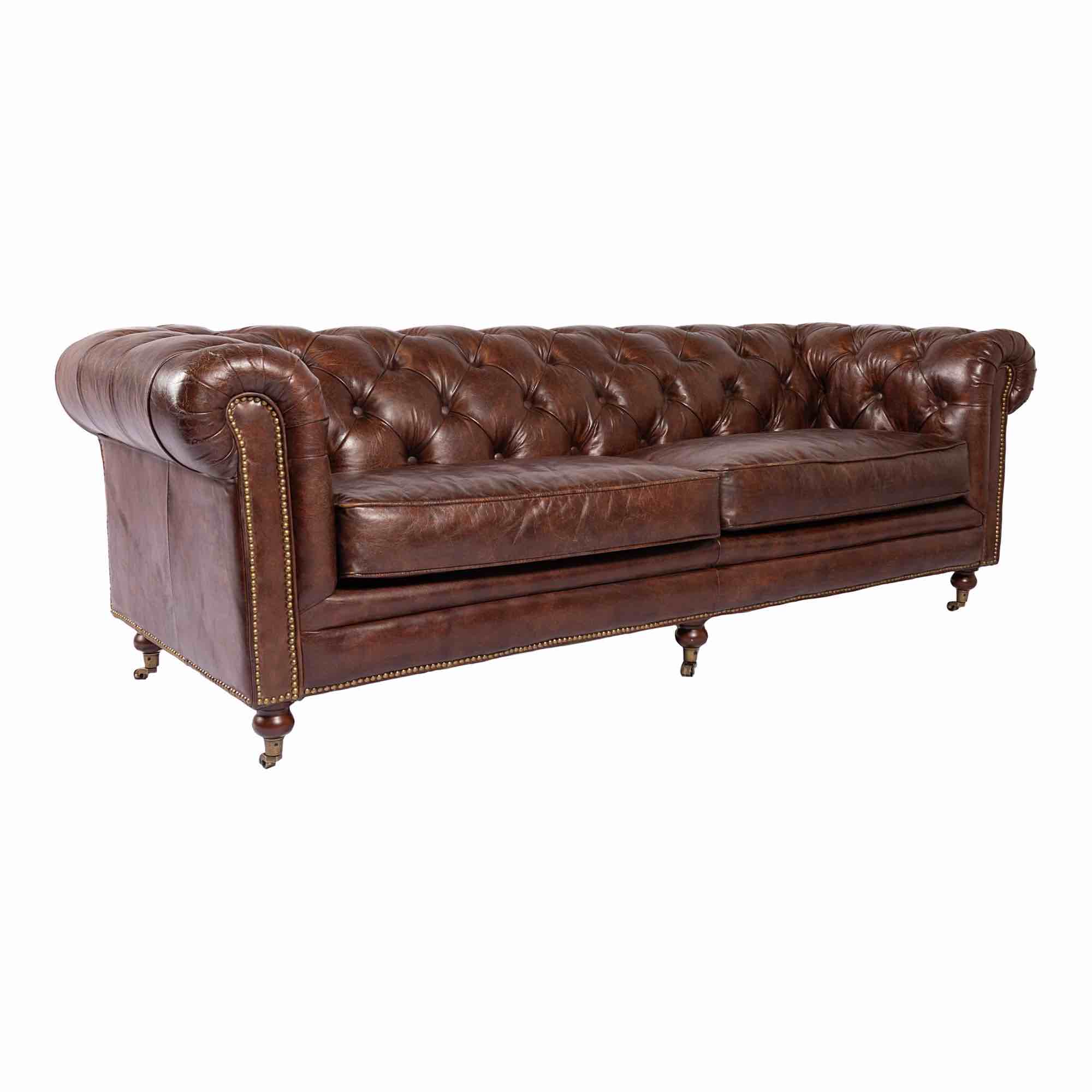 Condition photo showing New/Like New for birmingham dark brown top grain leather tufted sofa with bronze toned metal casters. 87"w x 36"d x 29"h
