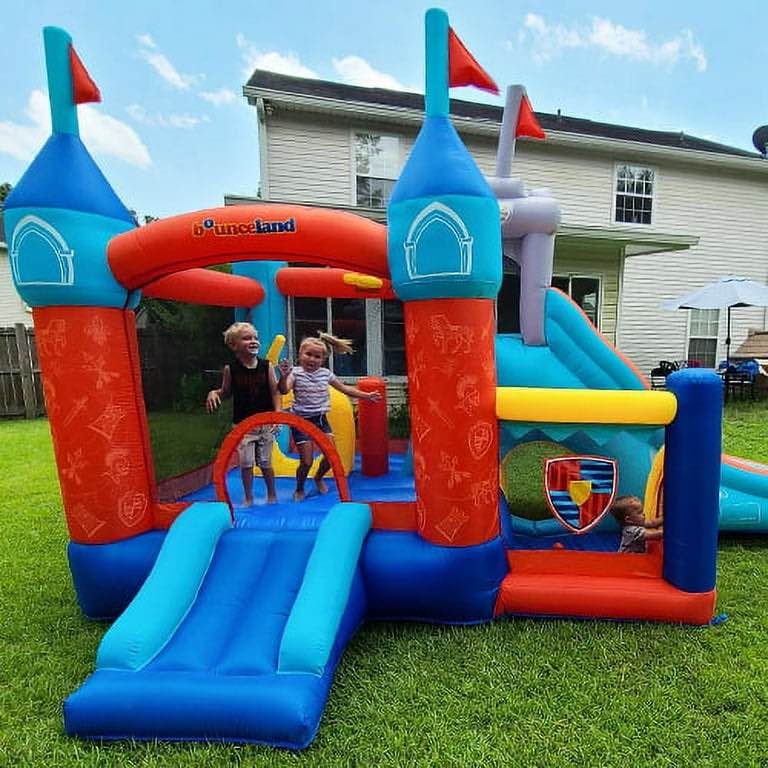 Condition photo showing New/Like New for red, yellow, and blue medieval bounce house with slide and rock wall. 16 ft l x 10.5 ft w x 9.7 ft h inflated size